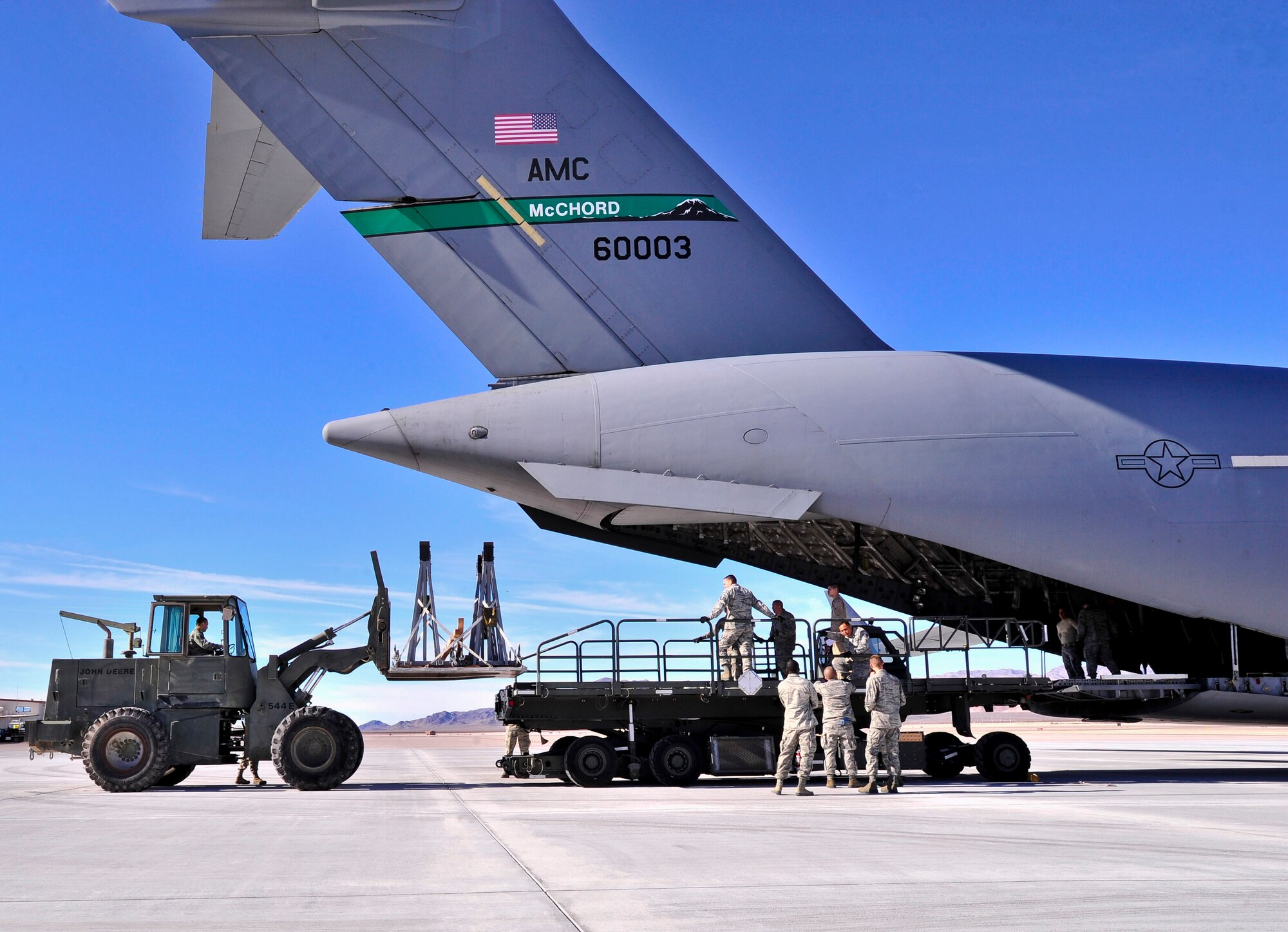 Aircraft support jacks are loaded onto a C-17 Globemaster by a forklift Dec. 30, 2013. Approximately half a dozen units worked together to ensure the remotely piloted aircraft equipment was prepared and ready to be shipped overseas in support of U.S. and coalition war fighters. (U.S. Air Force photo/Staff Sgt. A.D.)