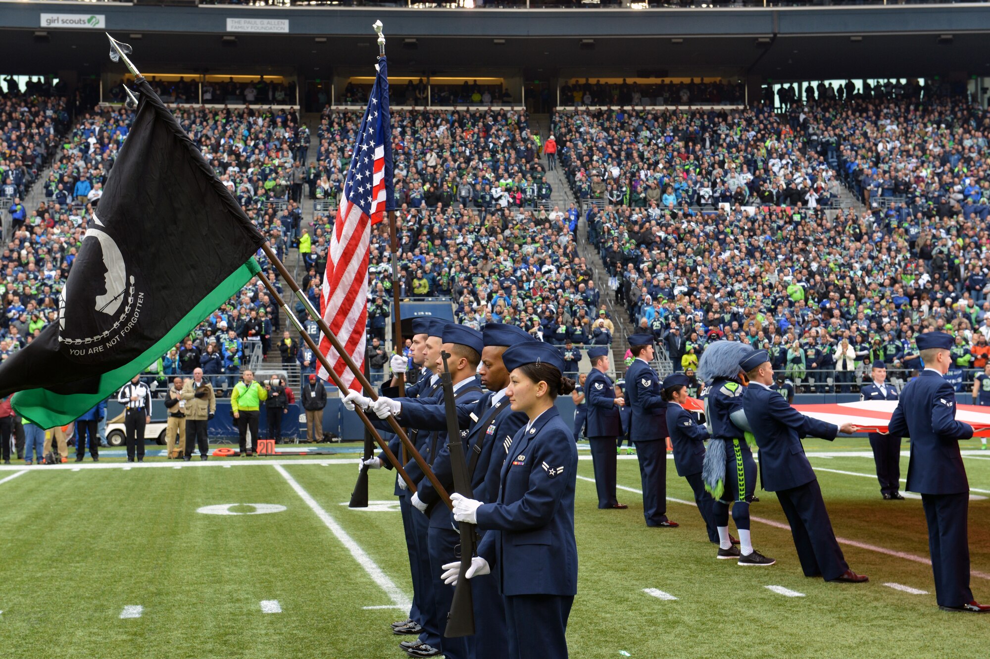 Team McChord Airmen participate in a flag detail as part of the pregame ceremony, Dec. 29, 2013 at CenturyLink Field in Seattle. Airmen from the 62nd Airlift Wing, 446th Airlift Wing and Western Area Defense Sector participated in the pregame detail. (U.S. Air Force photo/Master Sgt. Todd Wivell)