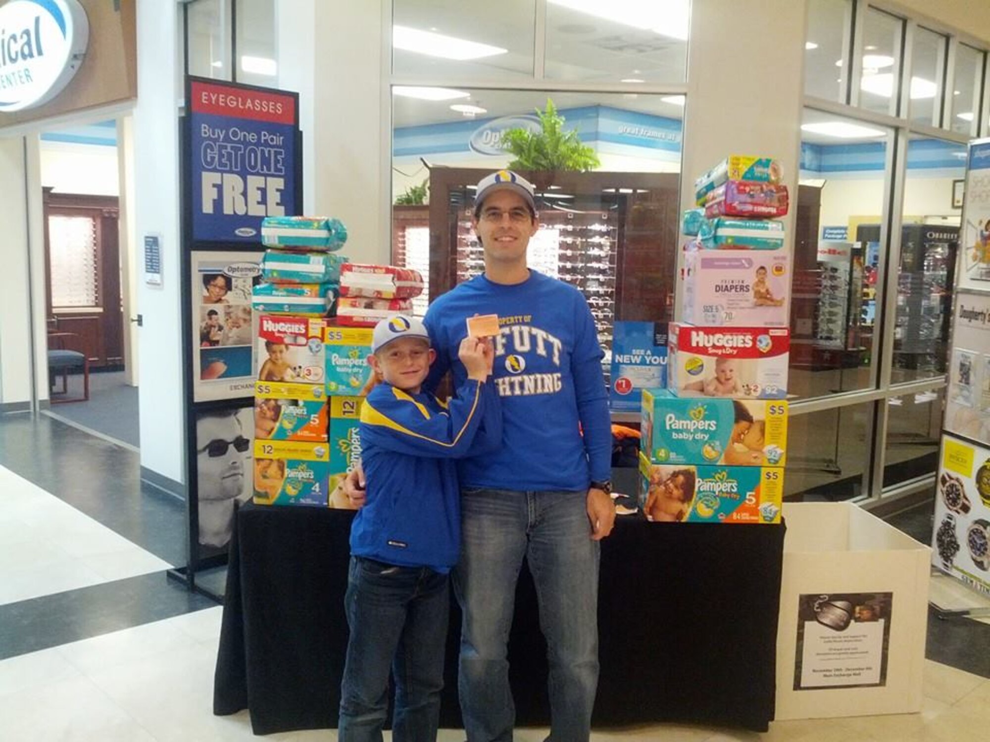 Matt and Kyle Rutherford of the Offutt Lightning gather up donations at the BX as part of Operation No Butts Left Behind.  This is the third year of the annual diaper drive that takes place at Offutt. (Courtesy photo)