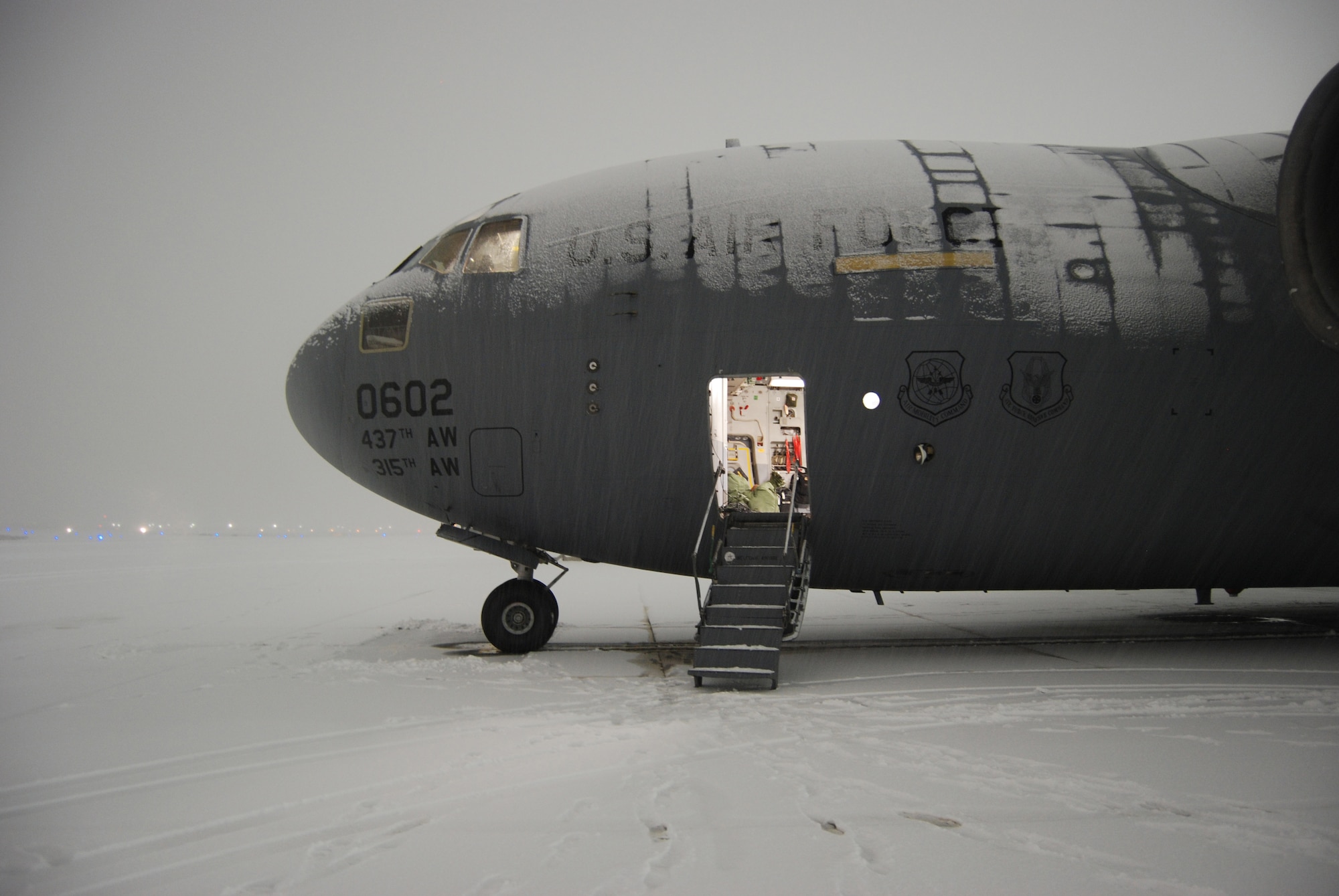 A C-17 Globemaster III sits on the flightline at Bagram Airfield, Afghanistan, Dec. 29, 2013. The aircrew landed in a snowstorm and aerial port Airmen downloaded and uploaded vehicles and cargo during the snowstorm. (U.S. Air Force Photo by Capt. Brian Wagner/Released)