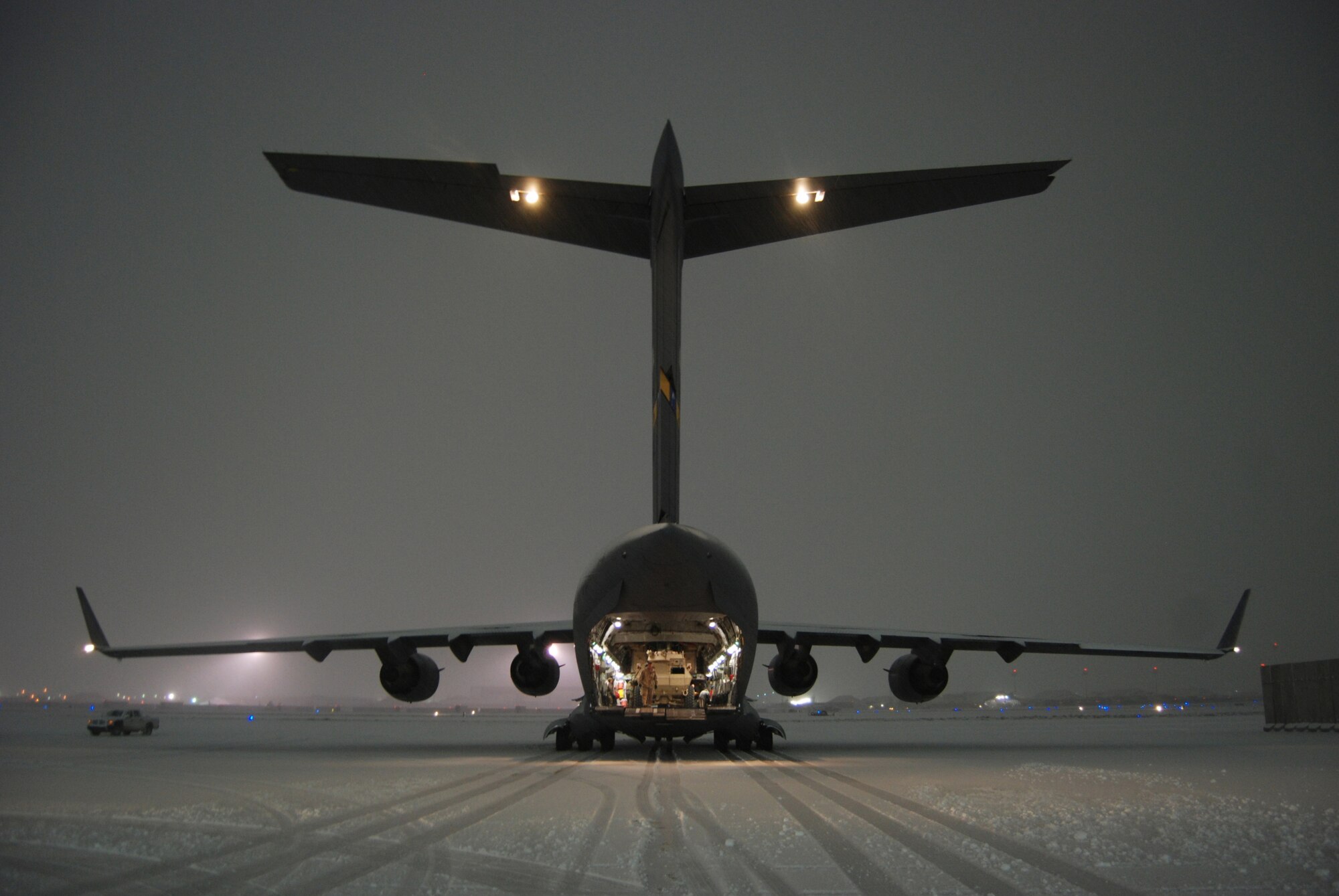 A C-17 Globemaster III sits on the flightline at Bagram Airfield, Afghanistan, Dec. 29, 2013. The aircrew and aerial port Airmen downloaded and uploaded vehicles and cargo during the snowstorm. (U.S. Air Force Photo by Capt. Brian Wagner/Released)