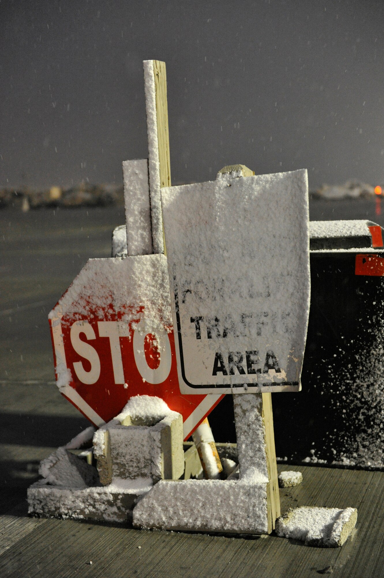 Signs directing forklift traffic on the flight line at Bagram Airfield, Afghanistan, sit covered in snow after the first snowfall of the year there, December 29, 2013.(U.S. Air Force photo by Senior Master Sgt. Gary J. Rihn/Released)