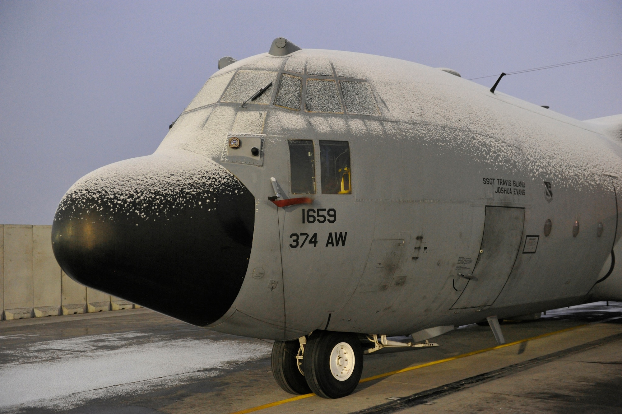 A C-130 sits covered in snow after the first snowfall of the year at Bagram Airfied, Afgghanistan, December 29, 2013.(U.S. Air Force photo by Senior Master Sgt. Gary J. Rihn/Released)