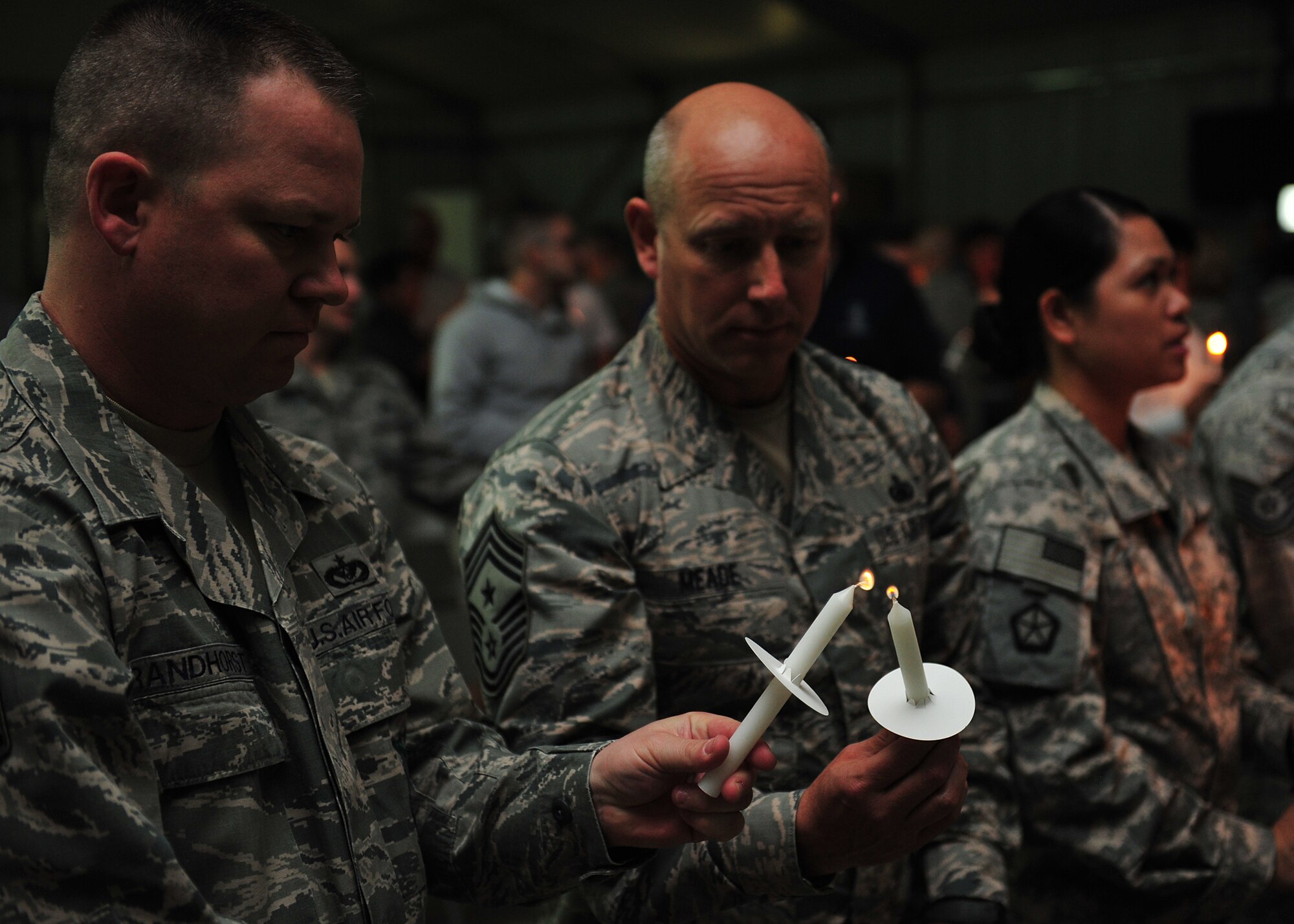 Members of the 380th Air Expeditionary Wing light candles during an ecumenical candlelight worship service at an undisclosed location in Southwest Asia, Dec. 22, 2013. Spiritual resilience includes but is not limited to worldviews, religious faith, sense of purpose, sense of connectedness, values, ethics and morals. (U.S. Air Force photo by Staff Sgt. Michael Means/Released)