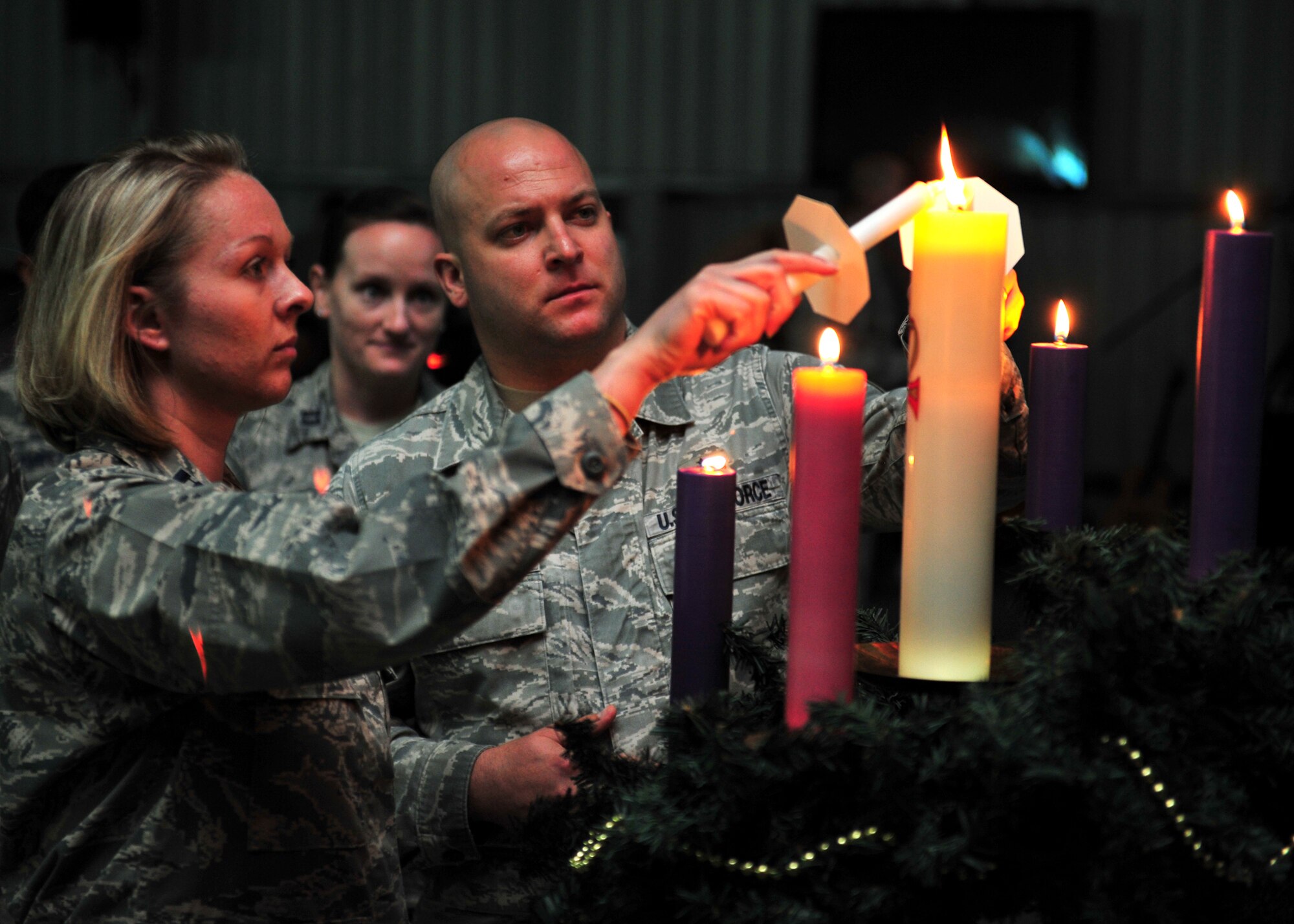 Members of the 380th Air Expeditionary Wing light candles during an ecumenical candlelight worship service at an undisclosed location in Southwest Asia, Dec. 22, 2013. Spiritual fitness is about having a sense of purpose and meaning in your life. It's essential to an individual's resiliency as esprit de corps is vital to a unit's mission accomplishment. (U.S. Air Force photo by Staff Sgt. Michael Means/Released)