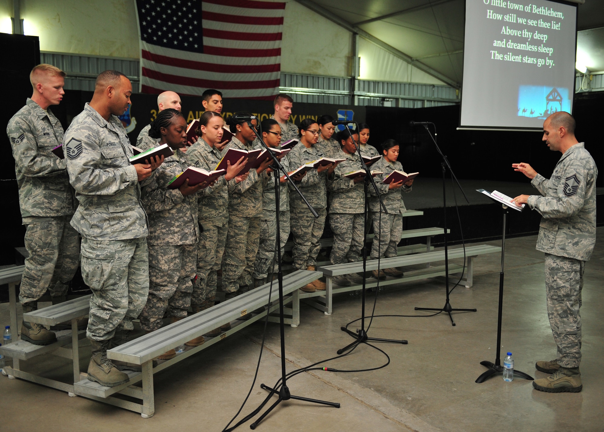 A combined choir from all Seven Sands Chapel services joined to sing during an ecumenical candlelight worship service at an undisclosed location in Southwest Asia, Dec. 22, 2013. The chapel reminds everyone to be spiritually resilient this holiday season. (U.S. Air Force photo by Staff Sgt. Michael Means/Released)