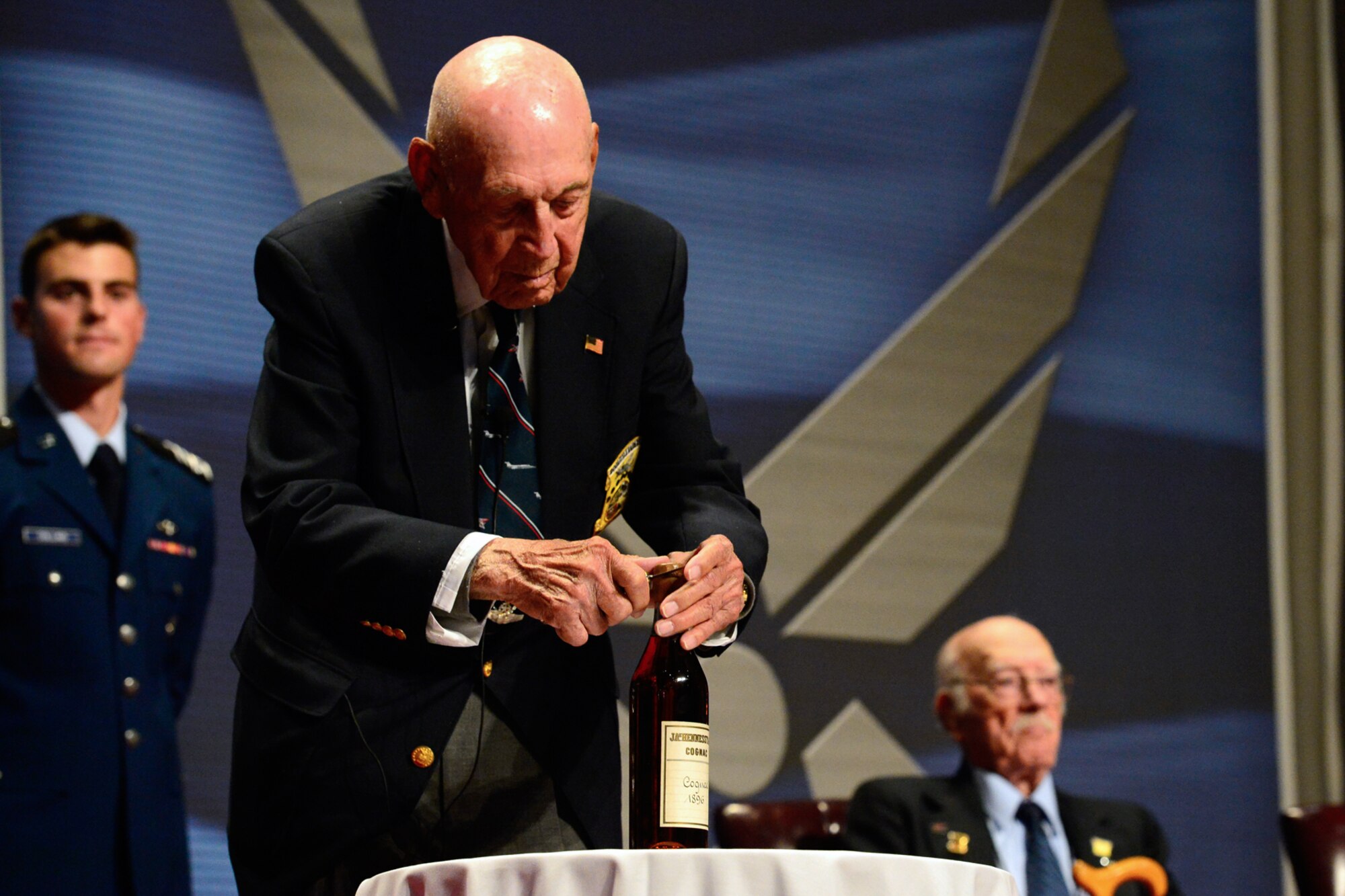 Retired Lt. Col. Richard “Dick” E. Cole opens the 1896 bottle of cognac before The Doolittle Tokyo Raiders shared their last and final toast at the National Museum of the U.S. Air Force Nov. 09, 2013 in Dayton, Ohio. Cole was the copilot of Aircraft No. 1. (U.S. Air Force photo/Desiree N. Palacios)