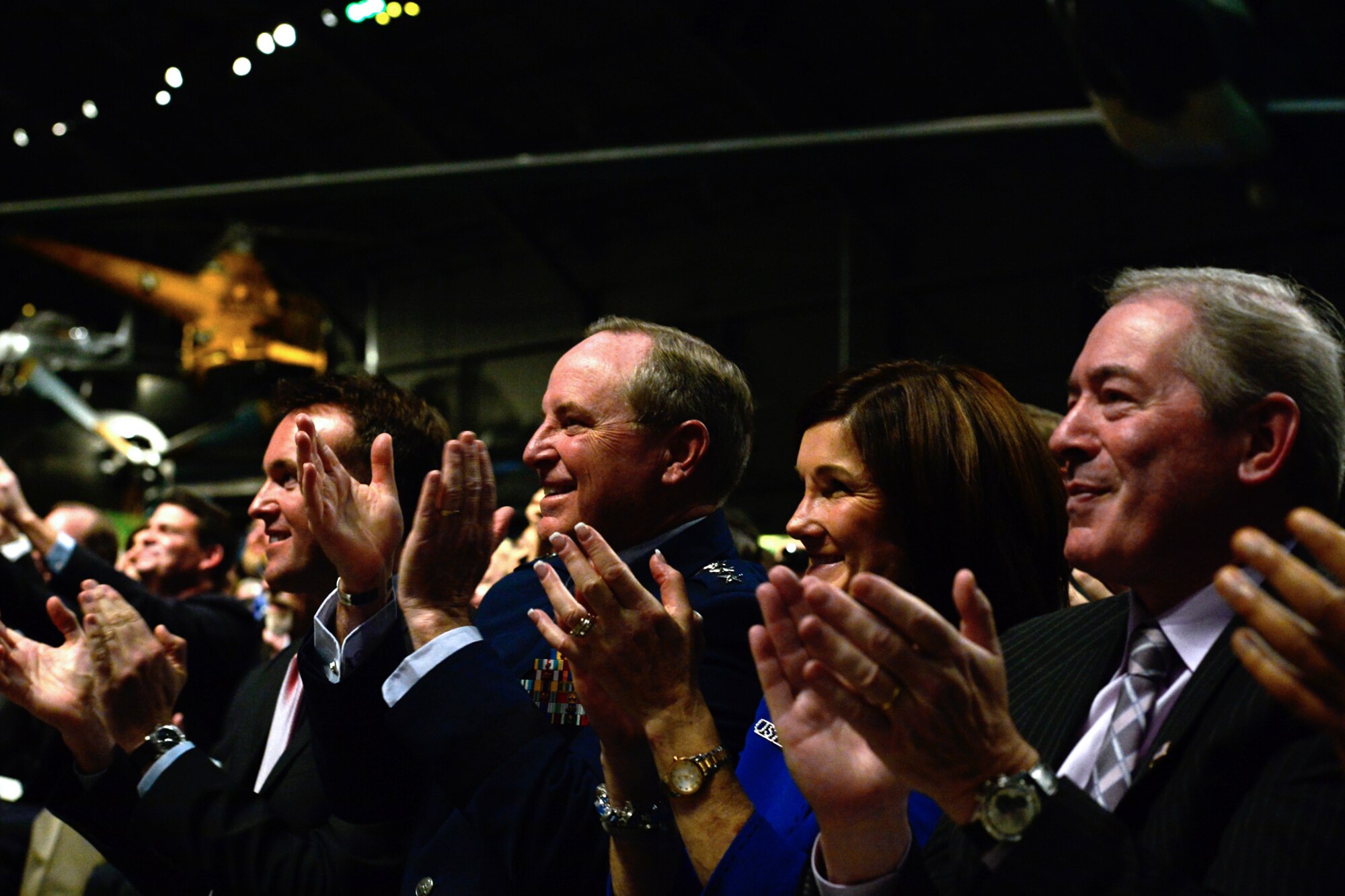 Acting Secretary of the Air Force Eric Fanning and Chief of Staff of the Air Force Gen. Mark A. Welsh III clap their hands after retired Lt. Col. Richard Cole opens the 1896 bottle of cognac during The Doolittle Raiders final toast at the National Museum of the U.S. Air Force Nov. 09, 2013 in Dayton, Ohio. Cole was the copilot of Aircraft No. 1. (U.S. Air Force photo/Desiree N. Palacios)