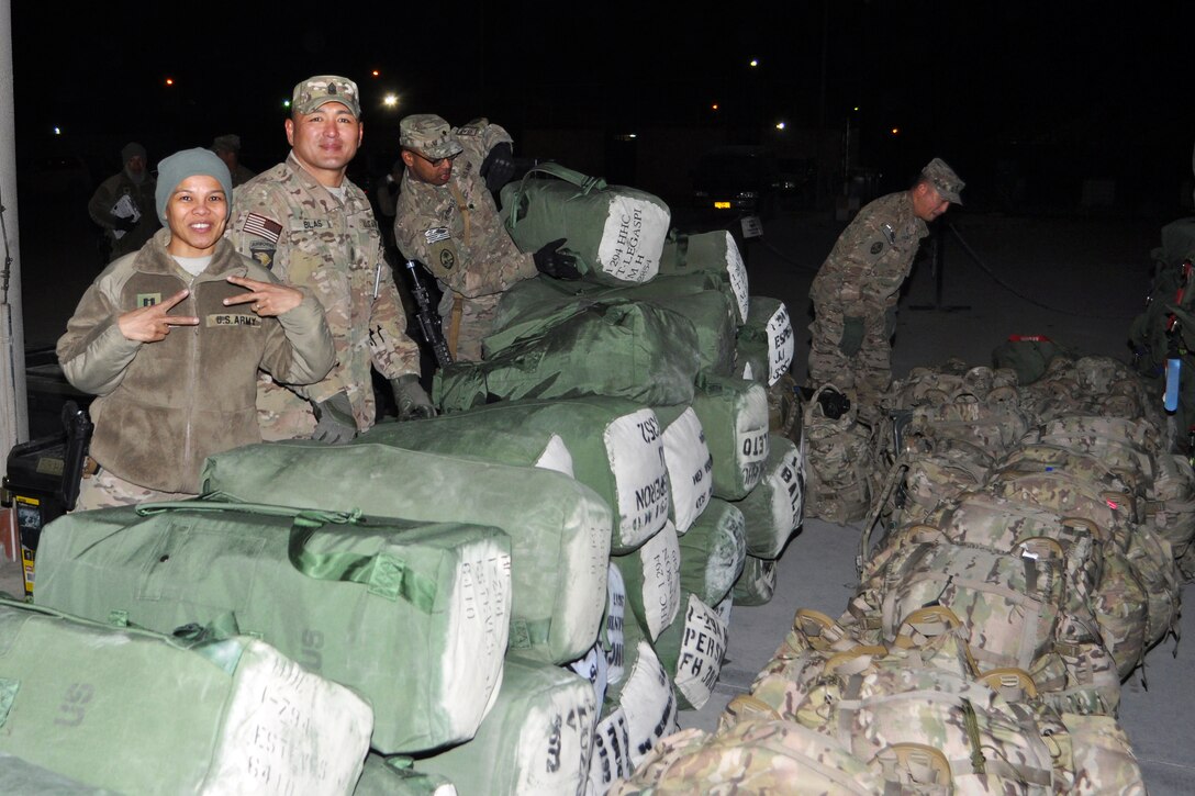 From left to right, U.S. Army Capt. Marleen Tarusan-Legaspi, U.S. Army Sgt. Maj. Manuel Blas, U.S. Army Spc. Fletcher Persinger and U.S. Army Chaplain Ronaldo Pascua prepare duffel bags in Kabul, Afghanistan, Dec. 28, 2013, during Task Force Guam's final departure from the country after concluding Operation Enduring Freedom. Tarusan-Legaspi, Blas, Persinger, and Pascua are assigned to Headquarters Company, 1st Battalion, 294th Infantry Regiment, Guam Army National Guard.