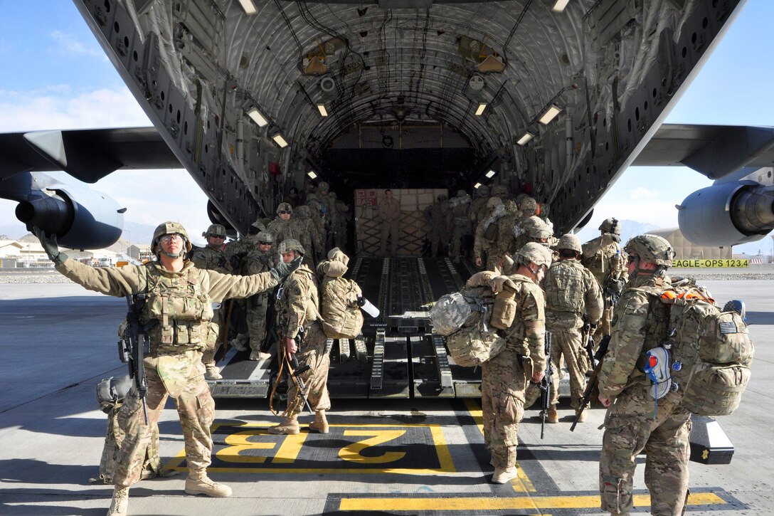 U.S. Army Sgt. 1st Class Frank Limtiaco, left, expresses gratitude as he departs with his unit for the final time in Kabul, Afghanistan, Dec. 28, 2013. Limtiaco is assigned to 1st Battalion, 294th Infantry Regiment, Guam Army National Guard.