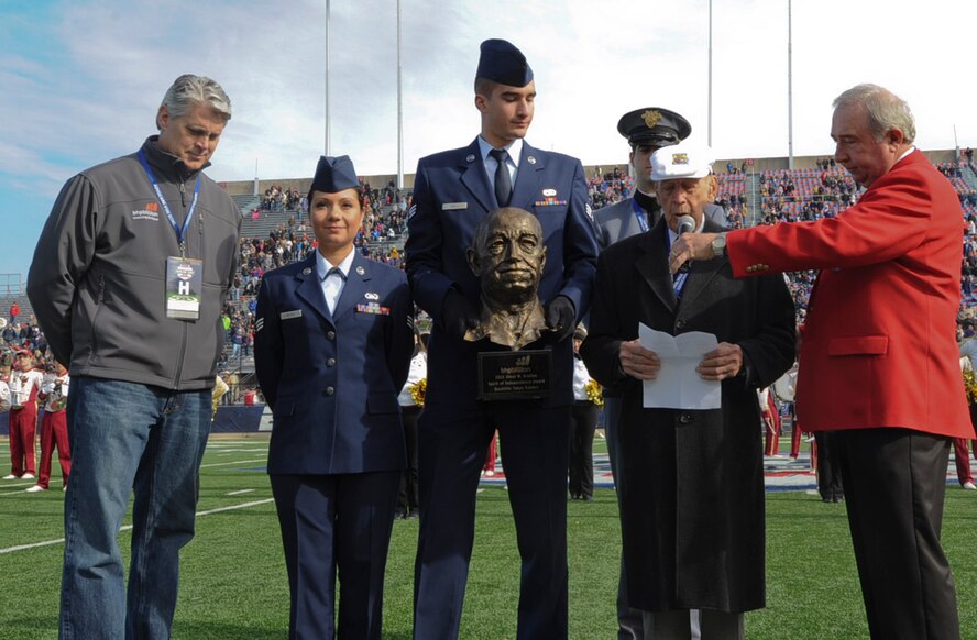 Retired Lt. Col. Richard E. Cole, Doolittle Raider copilot, receives the Omar N. Bradley Spirit of Independence Award on behalf of The Doolittle Raiders at the AdvoCare V100 Bowl in Shreveport, La., Dec. 31, 2013. The Doolittle Tokyo Raid was the first U.S. air retaliation attack after the attack on Pearl Harbor. (U.S. Air Force photo/Senior Airman Kristin High)