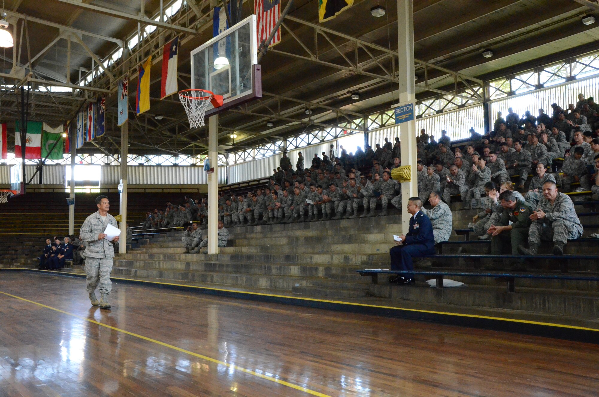 Staff Sgt. Randall "Randy" Mamalias, left, ground safety manager with the 624th Regional Support Group gives a mandatory safety briefing to members of the 624th RSG at the unit's quarterly commander's call held at Bloch Arena, Joint Base Pearl Harbor-Hickam, Hawaii, Dec. 7, 2013. Mamalias, a traditional reservist, is a captain with the federal fire department here on Oahu. Bloch Arena opened to servicemen in August 1941, four months before the Dec. 7, 1941 bombing of Pearl Harbor by the Japanese. Twenty years later, the singer Elvis Presley would play a benefit concert there to raise money for the Battleship Arizona Memorial. (U.S. Air Force photo by Tech. Sgt. Phyllis Keith)