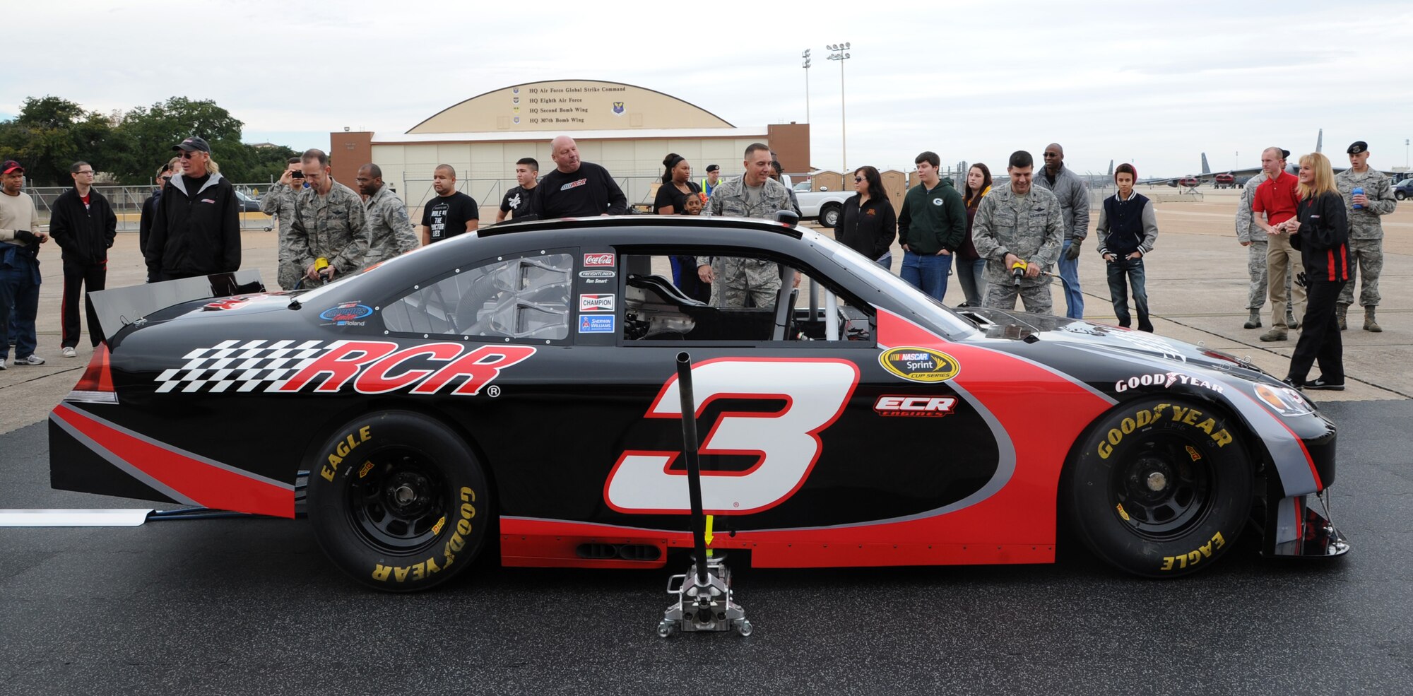 Col. Leland Bohannon, left, 2nd Bomb Wing vice commander, Chief Master Sgt. Curtis Storms, 2nd BW command chief, and Col. Andrew Gebara, 2nd BW commander, prepare to begin the pit crew challenge at Hoban Hall on Barksdale Air Force Base, La., Dec. 28, 2013. The three-man team simulated removing and replacing lug nuts on all four tires as fast as possible. (U.S. Air Force photo/Senior Airman Joseph A. Pagán Jr.)

