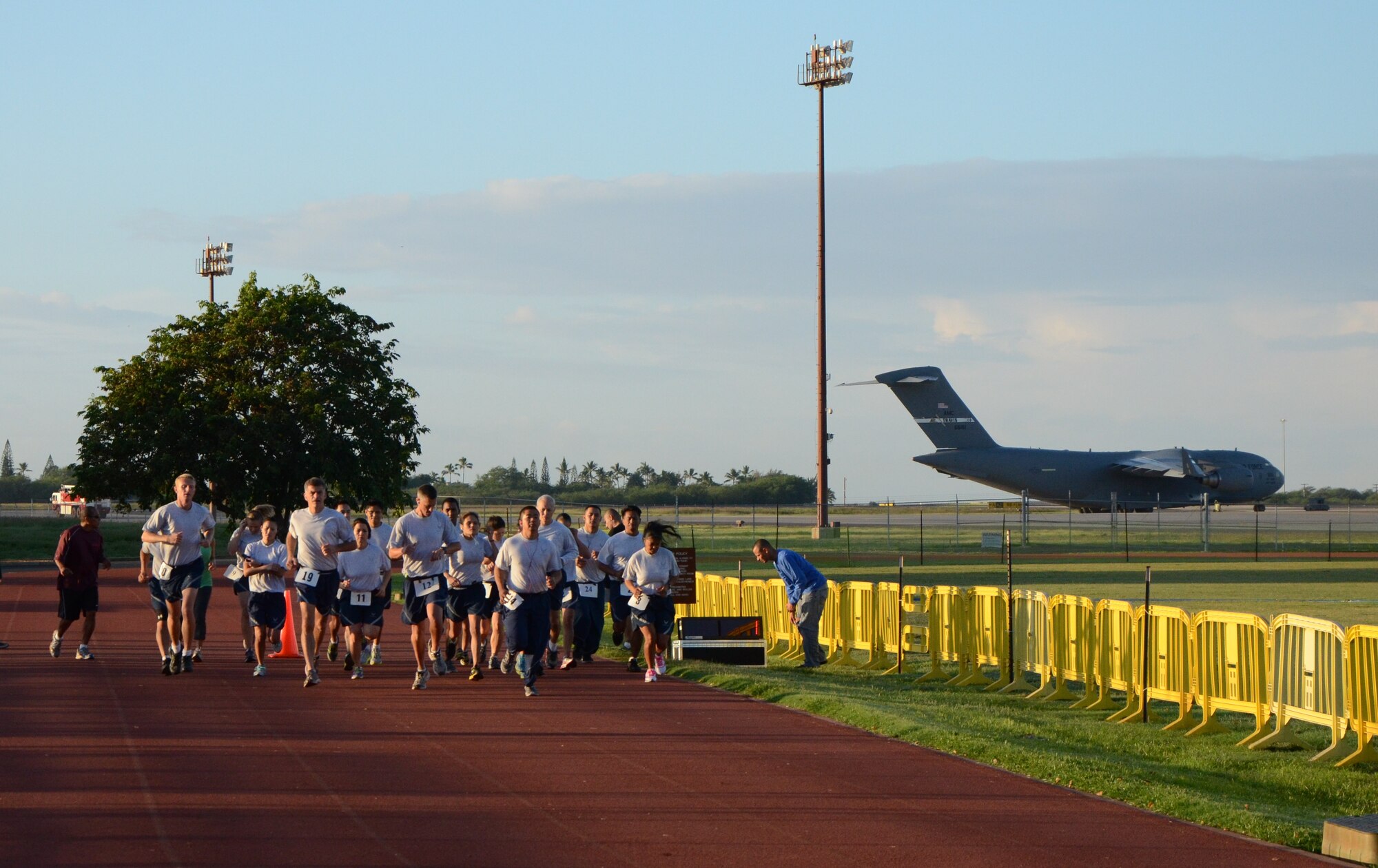Members of the 624th Regional Support Group take off running at Earhart Track, Joint Base Pearl Harbor-Hickam, Hawaii, Dec. 8, 2013. Every Sunday morning during the group's unit training assembly (UTA) a physical training (PT) test is administered to members who are due. Depending on one's fitness level, members will test every six months or once a year. (U.S. Air Force photo by Tech. Sgt. Phyllis Keith)