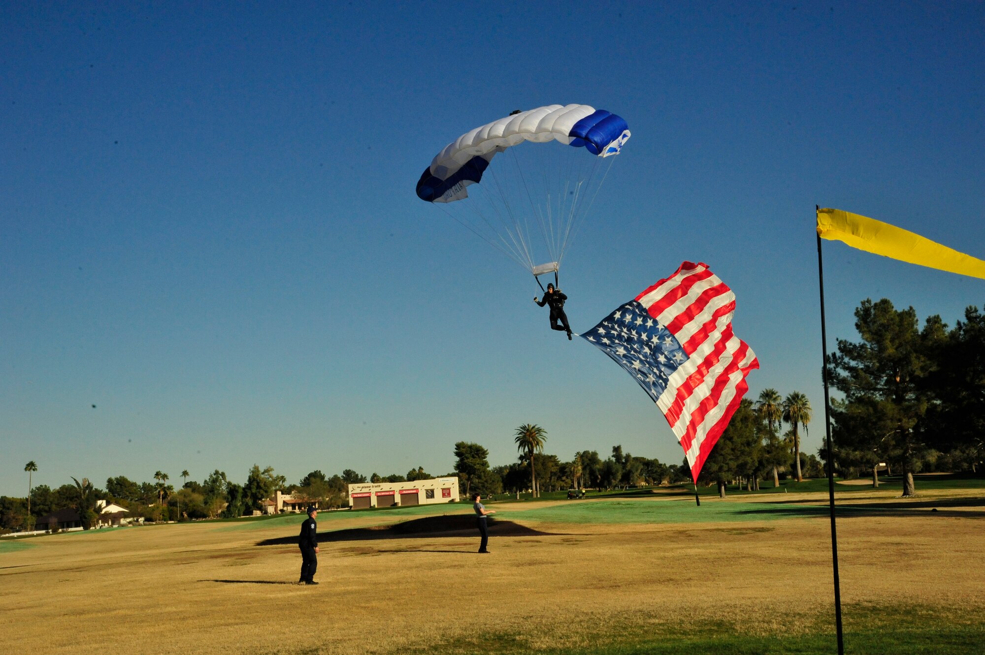 An Air Force Wings of Blue member makes an approach to land Friday at the Litchfield Golf Course in Litchfield Park, Ariz. Wings of Blue members do roughly 19,000 jumps per year for the Air Force basic freefalling course AM490 and training. (U.S. Air Force photo/Senior Airman Grace Lee)