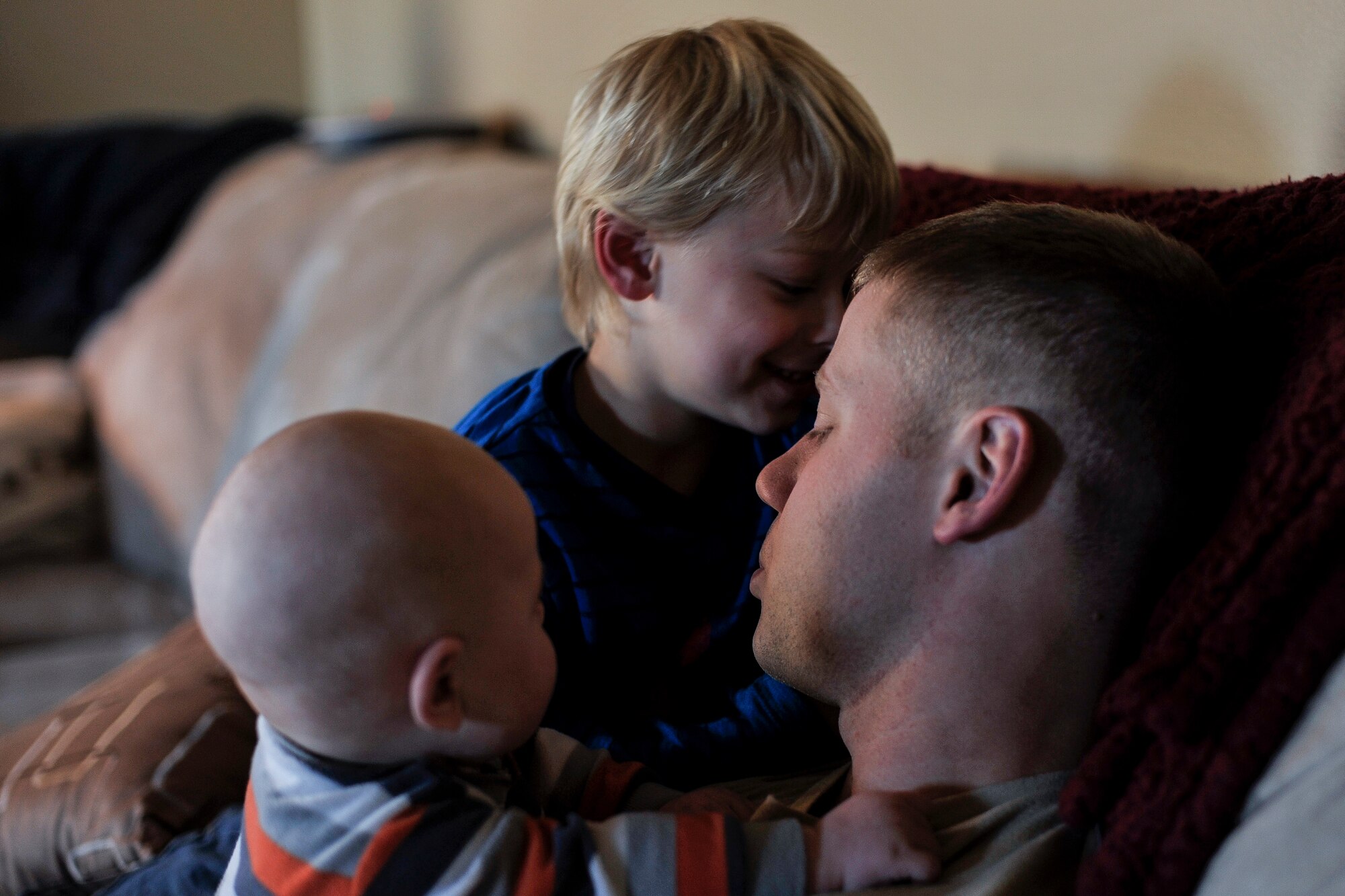 Tech. Sgt. Aaron Drain holds his sons, Ayden and Everett, on his first day home from a deployment to Afghanistan Jan. 23, 2013, in Cabot, Ark. Drain said he felt the need to tread lightly at first, and slowly work his way back into the boy’s lives. (U.S. Air Force photo by Staff Sgt. Russ Scalf)