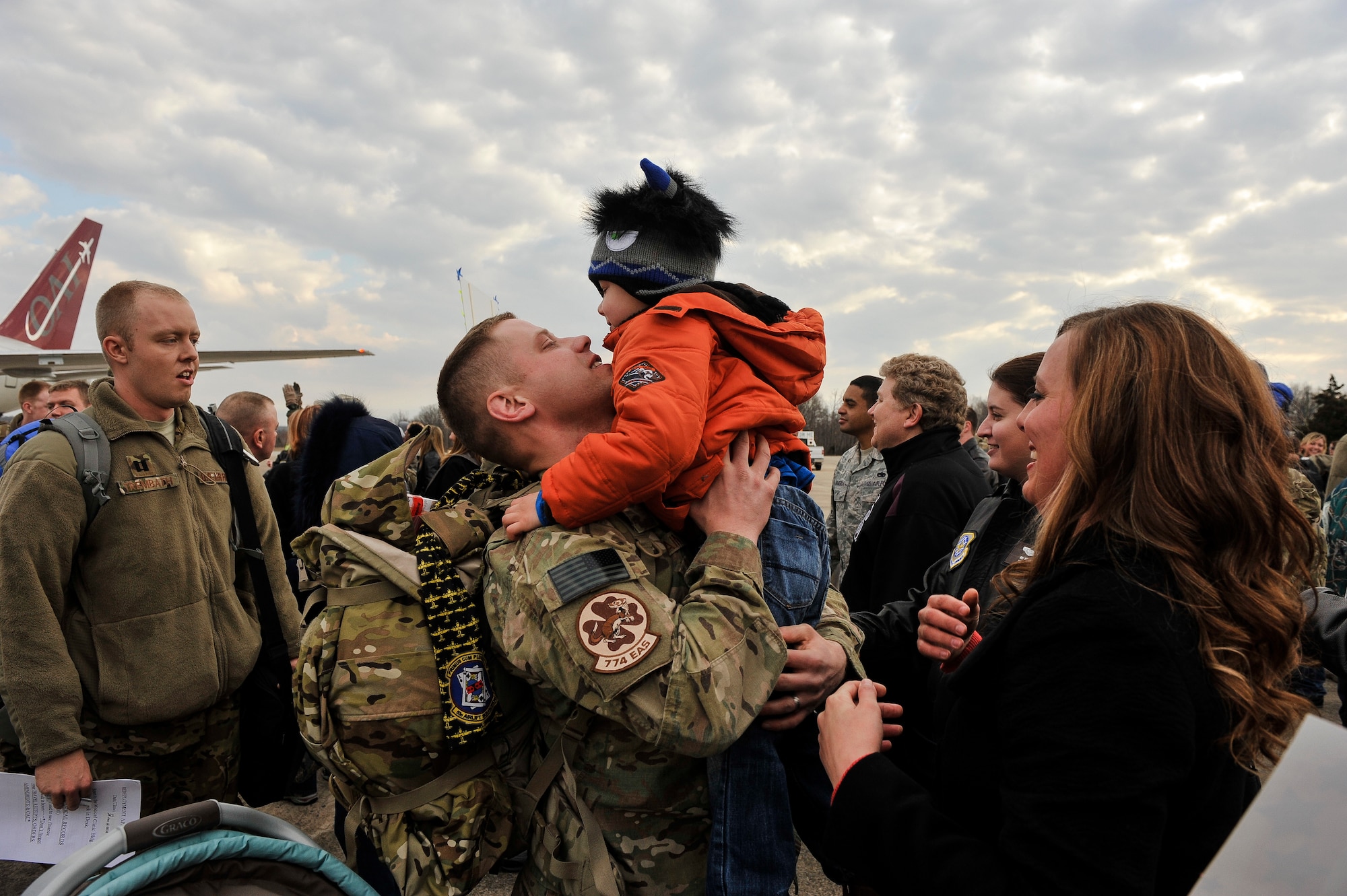 Tech. Sgt. Aaron Drain holds his son, Ayden, at a redeployment event on the flight line Jan. 23, 2013, at Little Rock Air Force Base, Ark. Drain said seeing his family again was an emotional event, and the entire experience of the deployment helped him realize the importance of family. (U.S. Air Force photo by Staff Sgt. Russ Scalf)