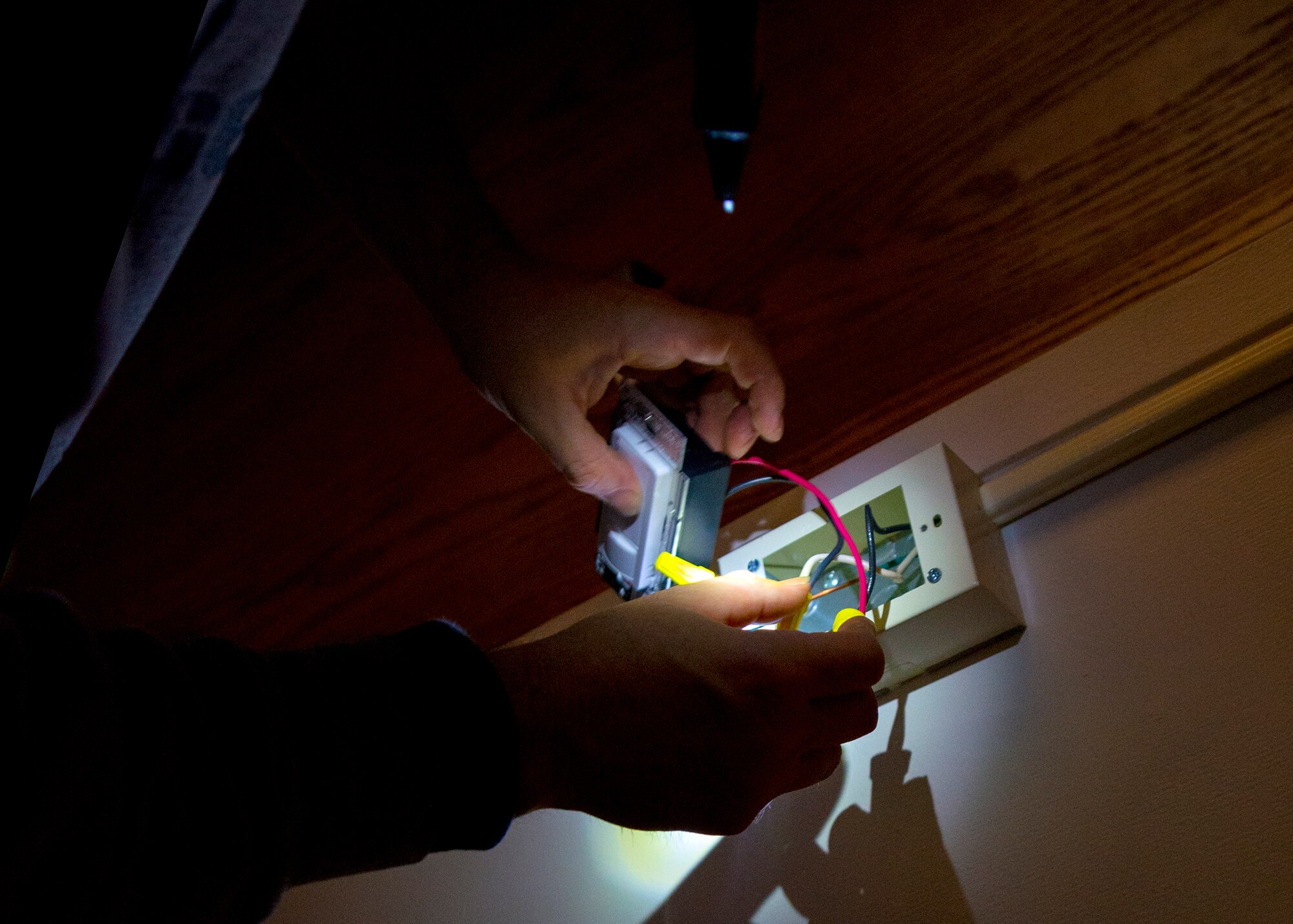 In an effort to save energy contractors install occupancy sensors in offices at the Niagara Falls Air reserve Station, November 26 2013 Niagara Falls, N.Y. These newly installed sensors automatically turn off the lights when a room is left unoccupied for 10 minutes, turning them back on when personnel re-enter. (U.S. Air Force photo by Tech. Sgt. Joseph McKee)