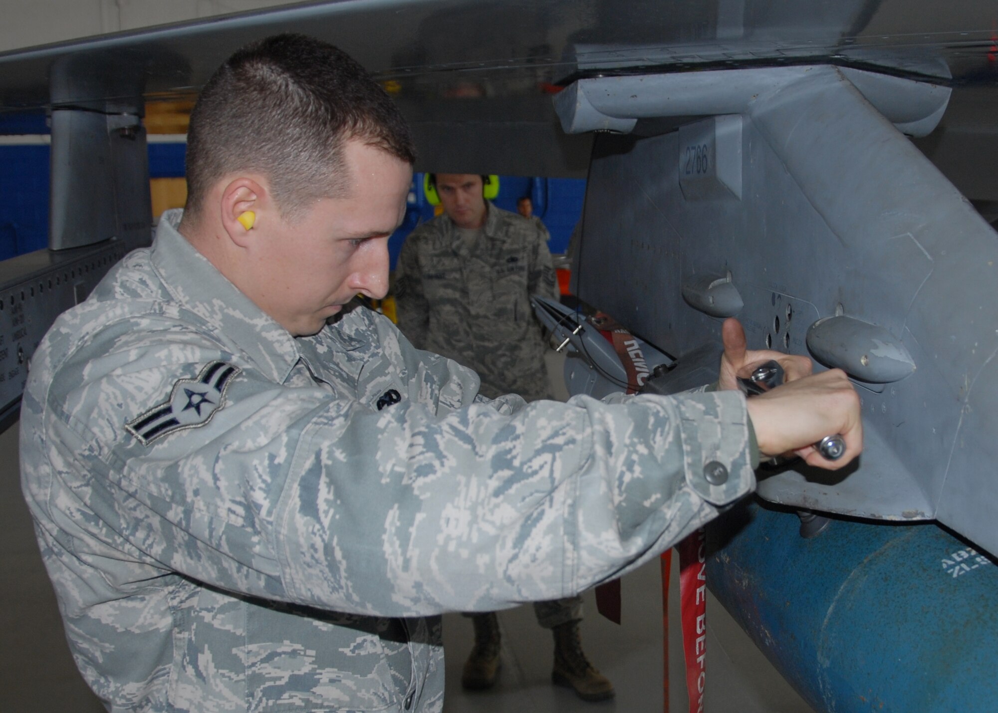 Airman 1st Class Brandon Browning, of the 96th Aircraft Maintenance Squadron Blue, sways the Guided Bomb Unit to their F-16 Fighting Falcon during the 96th Maintenance Group’s quarterly weapons loadcrew competition Dec. 20 at Eglin Air Force Base, Fla. The Blue AMU team of Staff Sgt. Kevin Vinson, Airman First Class Derron Ackermann and Browning won the competition. (U.S. Air Force photo/Kevin Gaddie)