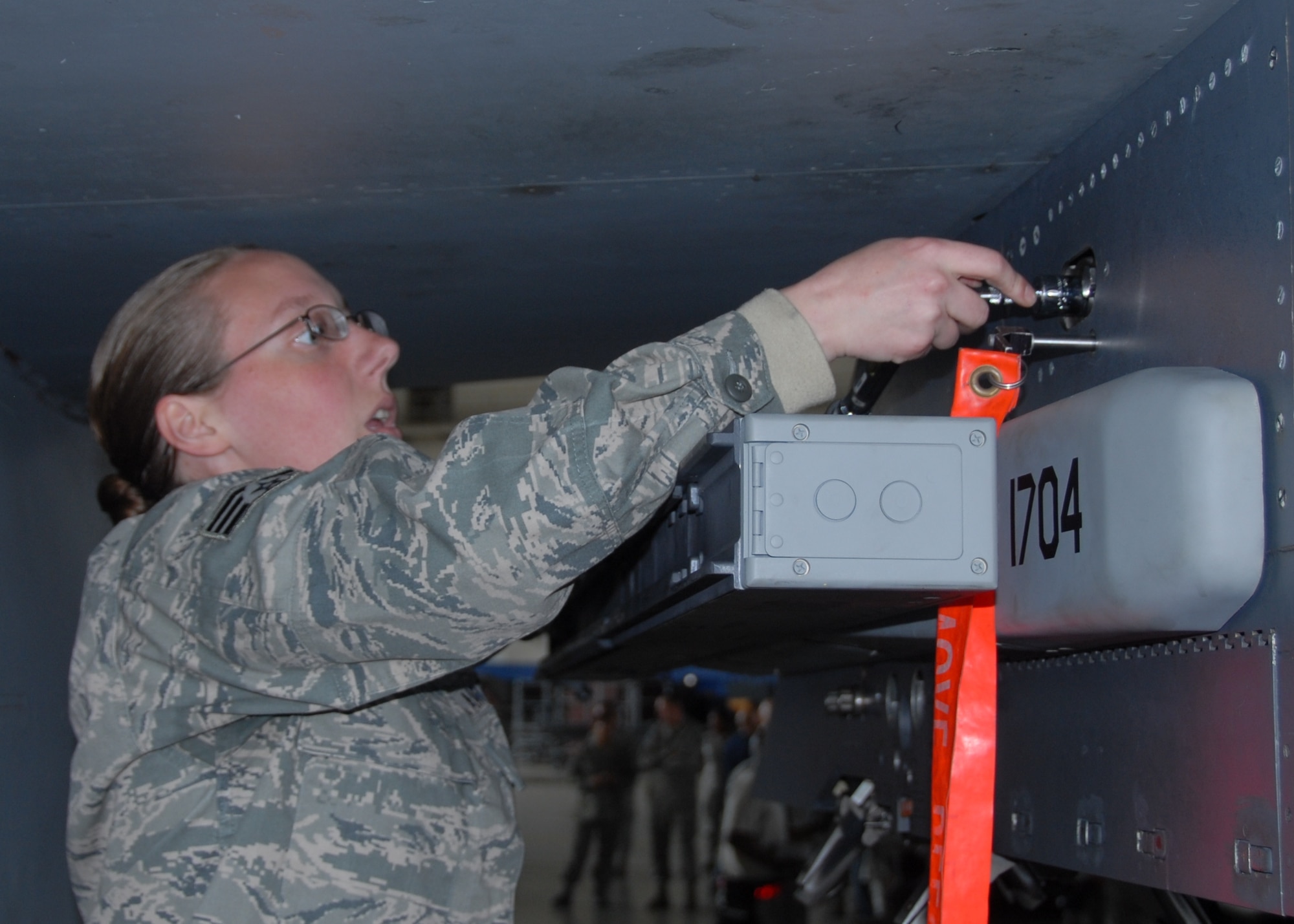 Senior Airman Kortni Brewer of the 96th Aircraft Maintenance Squadron Red, removes impulse carts from the bomb rack of their F-15 during the 96th Maintenance Group’s quarterly weapons loadcrew competition Dec. 20 at Eglin Air Force Base, Fla.  Staff Sgt. Damon Clark, Senior Airman Horace Brown and Brewer represented the Red AMU.  AMU Blue won the competition. (U.S. Air Force photo/Kevin Gaddie)