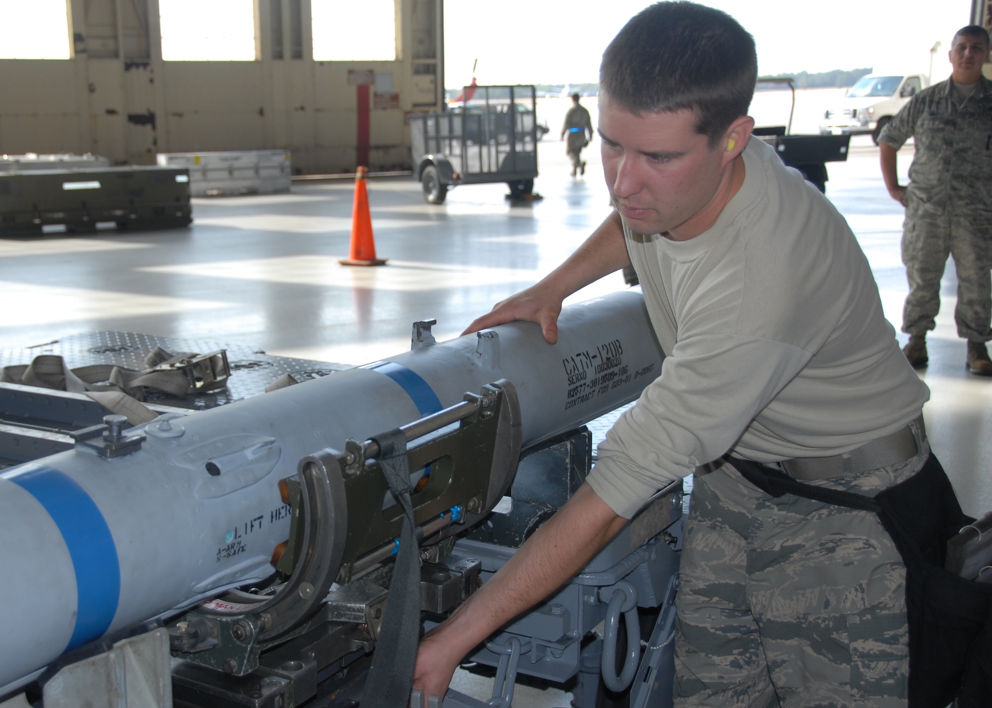 Staff Sgt. Kevin Vinson, of the 96th Aircraft Maintenance Squadron Blue, loads an AIM-120 on to a one step loading adapter during the 96th Maintenance Group’s quarterly weapons loadcrew competition Dec. 20 at Eglin Air Force Base, Fla. Vinson, Senior Airman Derron Ackermann and Airman First Class Brandon Browning represented the Blue AMU. The Blue team defeated the Red team in the competition. (U.S. Air Force photo/Kevin Gaddie)