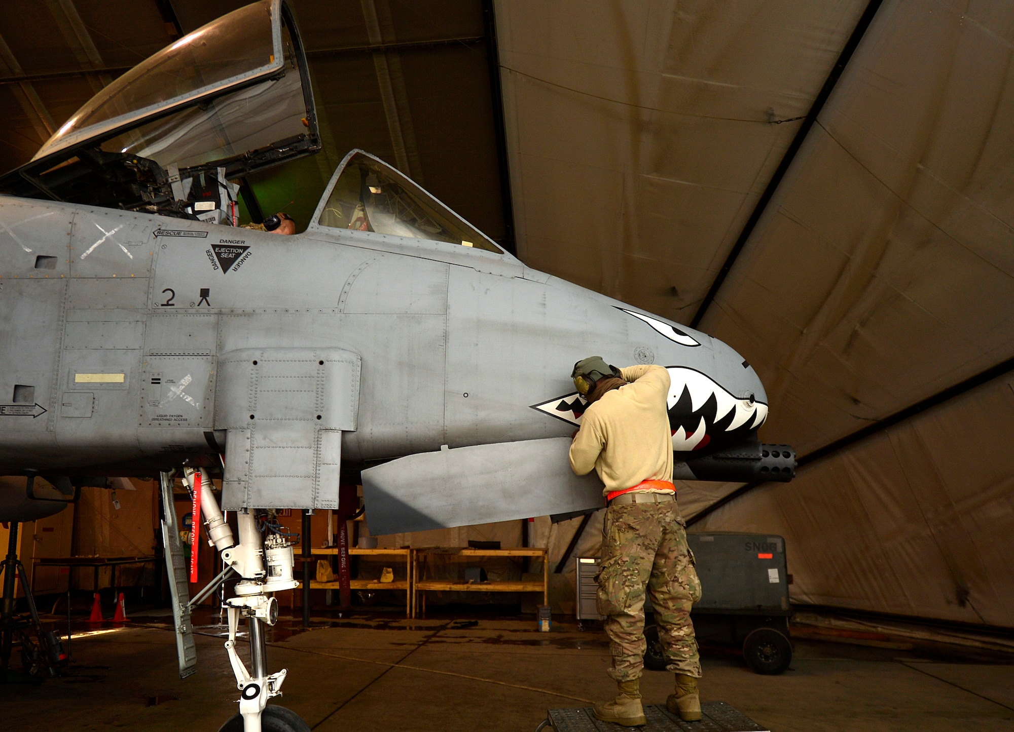 U.S. Air Force Senior Airman Craig Irvine, 455th Expeditionary Maintenance Squadron A-10 Thunderbolt II sheet metal technician, grinds down metal on an A-10 Thunderbolt II at Bagram Airfield, Afghanistan, Dec. 30, 2013. The A-10 Thunderbolt II has a wide combat radius and short takeoff and landing capabilities, as well as being able to provide close-air support for troops on the ground.  Irvine is deployed from the 23rd Equipment Maintenance Squadron at Moody Air Force Base, Ga., and is a native of Lake Charles, La. (U.S. Air Force photo by Senior Airman Kayla Newman/Released)