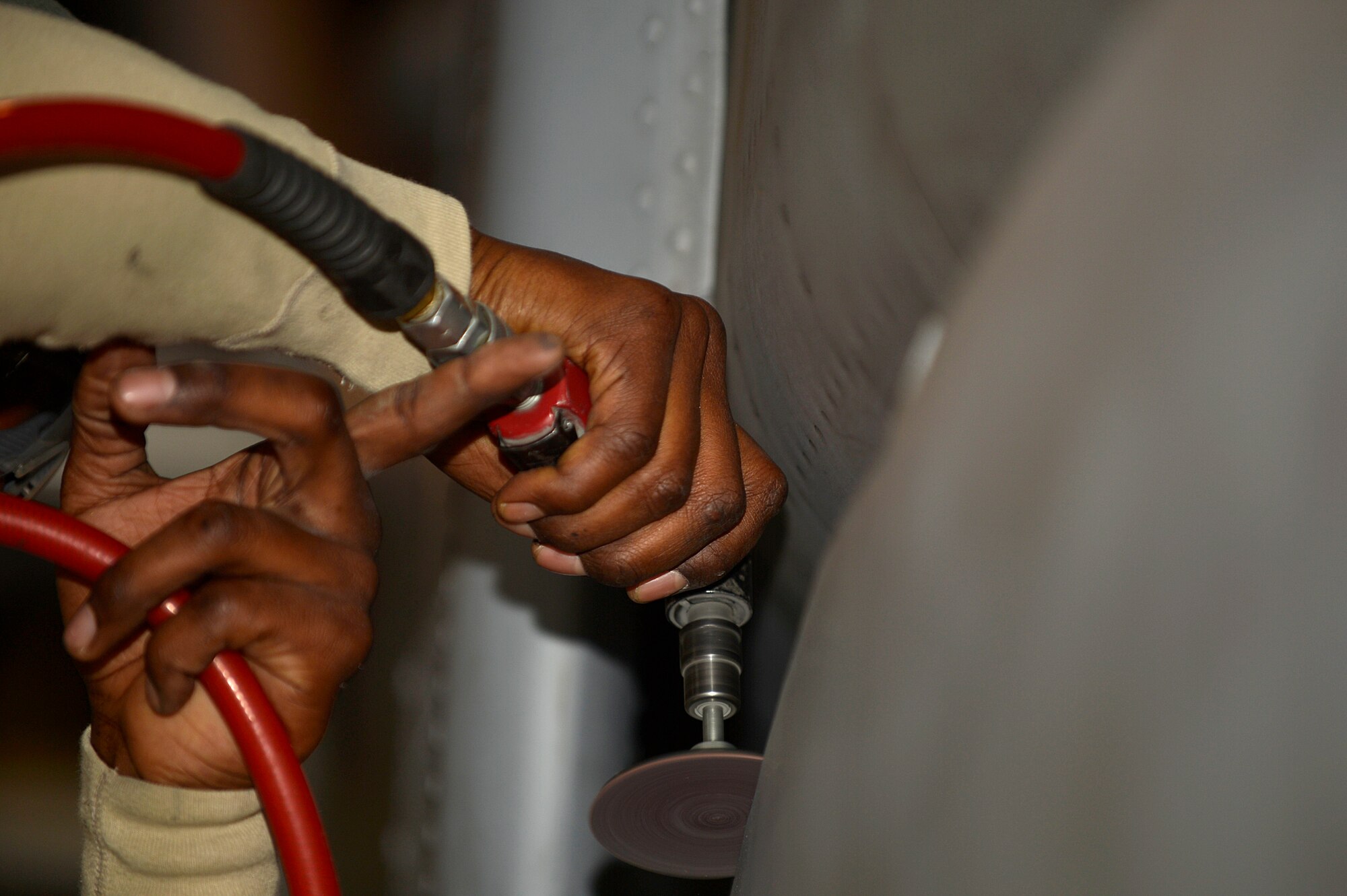U.S. Air Force Senior Airman Craig Irvine, 455th Expeditionary Maintenance Squadron A-10 Thunderbolt II sheet metal technician, grinds down metal on an A-10 Thunderbolt II at Bagram Airfield, Afghanistan, Dec. 30, 2013. The A-10 Thunderbolt II has a wide combat radius and short takeoff and landing capabilities, as well as being able to provide close-air support for troops on the ground. Irvine is deployed from the 23rd Equipment Maintenance Squadron at Moody Air Force Base, Ga., and is a native of Lake Charles, La. (U.S. Air Force photo by Senior Airman Kayla Newman/Released)