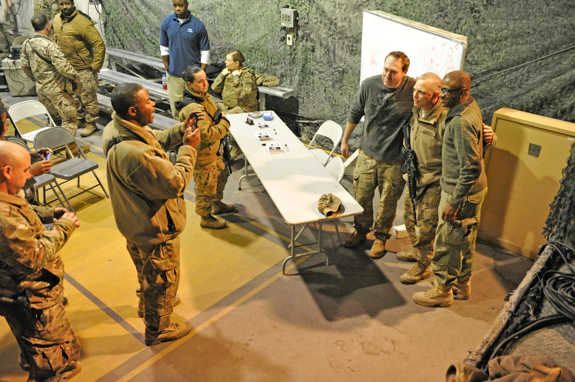 Comedians Rob Maher and Tommy Davidson pose for pictures after their show at Bagram Airfield, Afghanistan, Dec. 31, 2013. The two performed a comedy routine for deployed Service members on New Year's Eve.(U.S. Air Force photo by Senior Master Sgt. Gary J. Rihn/Released)