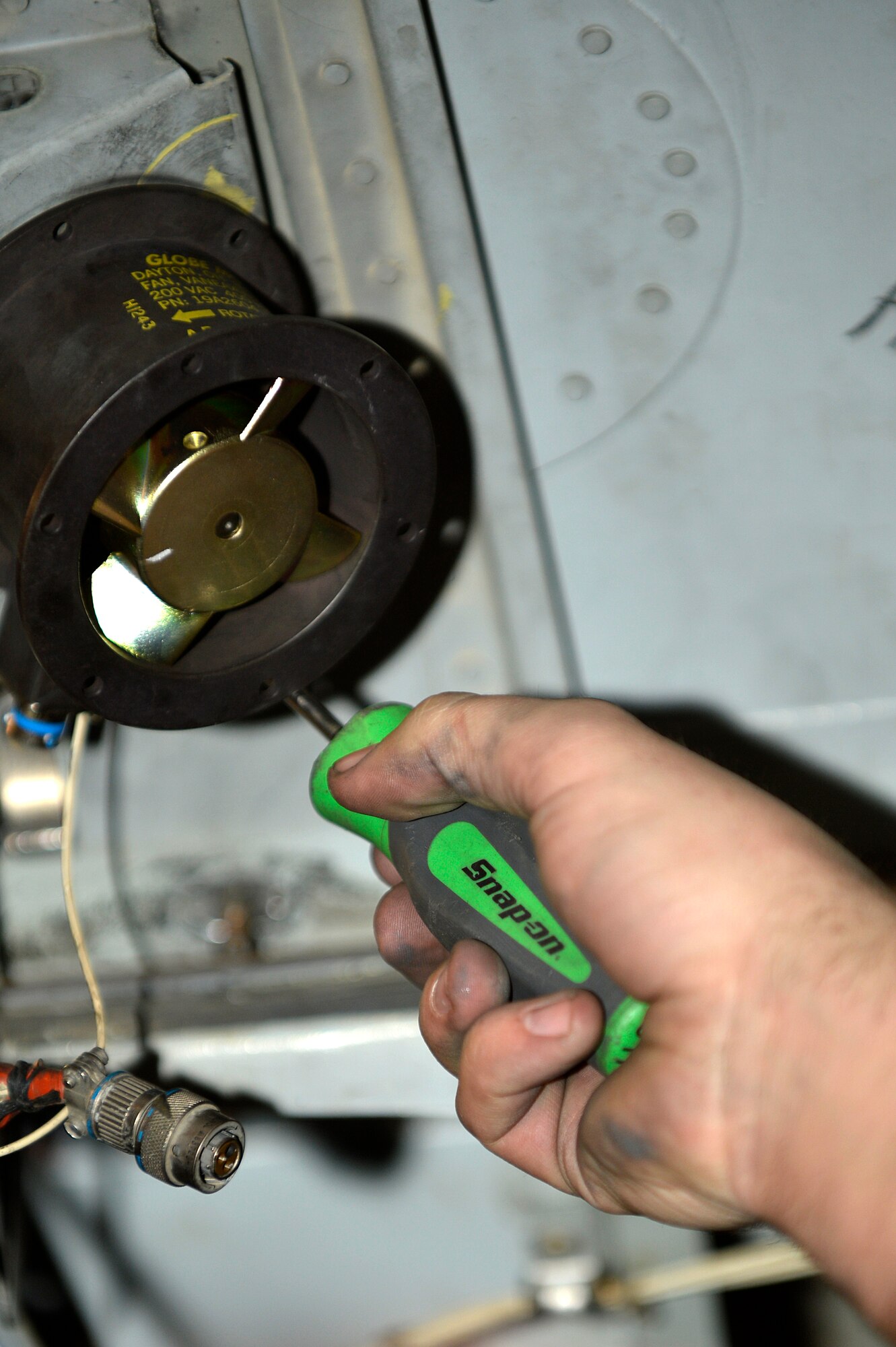 U.S. Air Force Airman 1st Class Jarred Sozzi, 455th Expeditionary Maintenance Squadron, replaces an avionics costing fan on an A-10 Thunderbolt II at Bagram Airfield, Afghanistan, Dec. 30, 2013. The A-10 Thunderbolt II has a wide combat radius and short takeoff and landing capabilities, as well as being able to provide close-air support for troops on the ground. Sozzi is deployed from the 23rd Component Maintenance Squadron at Moody Air Force Base, Ga., and is a native of Tampa, Fla. (U.S. Air Force photo by Senior Airman Kayla Newman/Released)