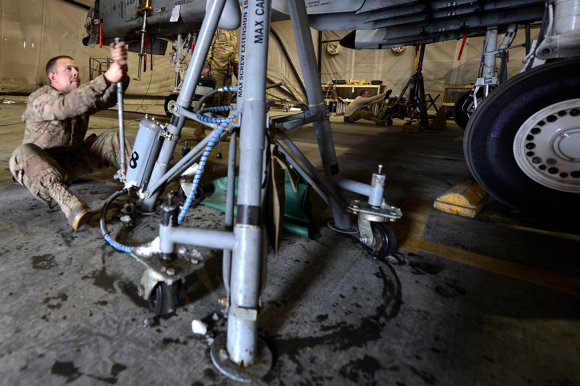 U.S. Air Force Senior Airman Larry Webb, 455th Expeditionary Maintenance Squadron A-10 Thunderbolt II crew chief, raises an A-10 Thunderbolt II at Bagram Airfield, Afghanistan, Dec. 30, 2013. After spending a certain amount of time in the air, the A-10’s must receive routine maintenance.  Webb is deployed from the 23rd Aircraft Maintenance Squadron from Moody Air Force Base, Ga., and a native of Canton, Ga. (U.S. Air Force photo by Senior Airman Kayla Newman/Released)