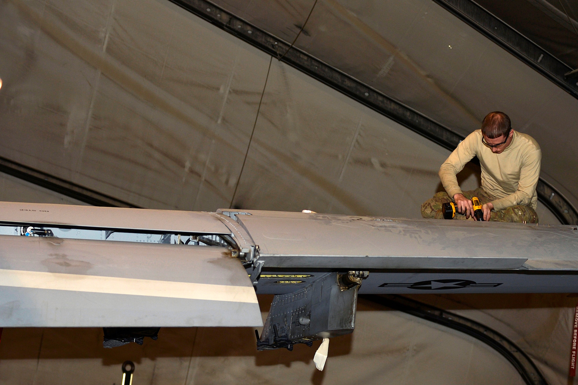 U.S. Air Force Staff Sgt. Tom Wilson, 75th Expeditionary Maintenance Squadron crew chief, works on a A-10 Thunderbolt II at Bagram Airfield, Afghanistan, Dec. 30, 2013. After spending a certain amount of time in the air, the A-10’s must receive routine maintenance.  (U.S. Air Force photo by Senior Airman Kayla Newman/Released)