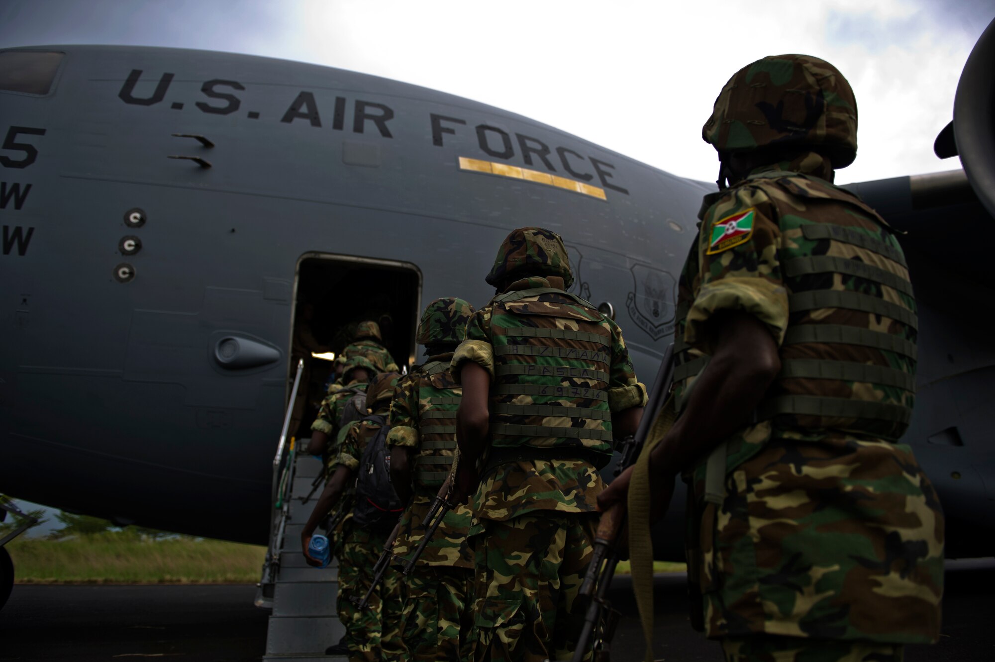 Burundi soldiers wait to board a Joint Base Charleston C-17 Globemaster Dec. 17, 2013 at Bujmumbura Airport, Burundi. In coordination with the French military and African Union, the U.S. military provided airlift support to transport Burundi soldiers, food and supplies in the Central African Republic. This support is aimed at enabling African forces to deploy promptly to prevent further spread of sectarian violence and restore security in CAR. (U.S. Air Force photo by Staff Sgt. Erik Cardenas)


