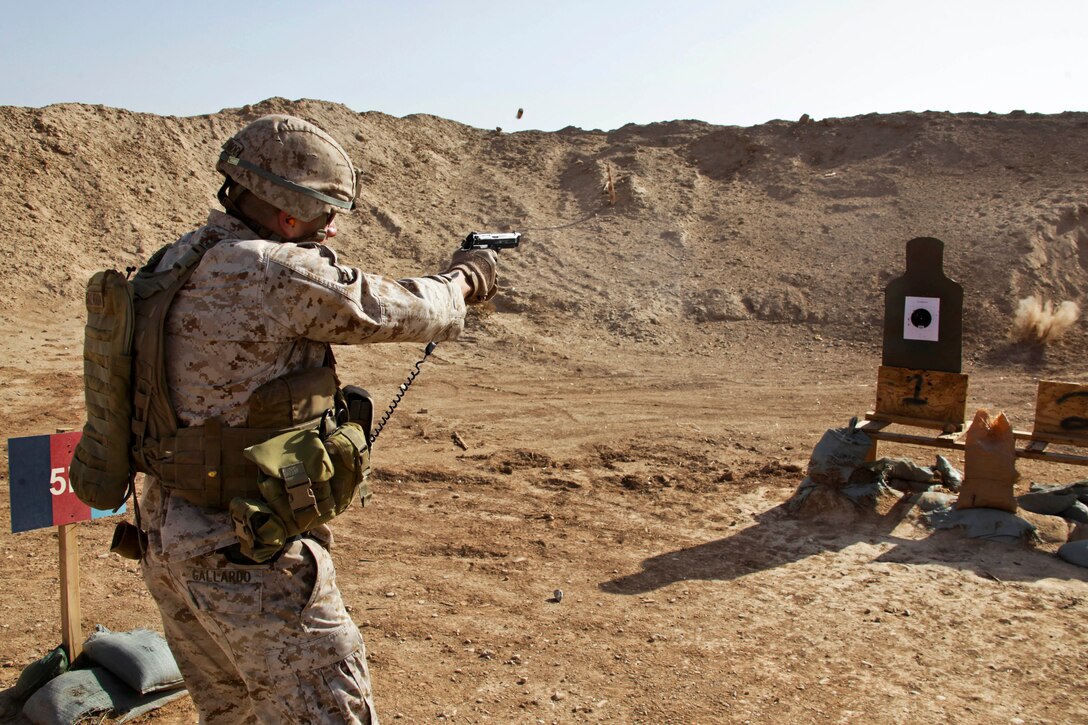 U.S. Marine Corps 1st Sgt. Juan Gallardo fires a 9mm pistol during a battle sight zero at a range on Camp Leatherneck in Helmand province, Afghanistan, Dec. 22, 2013. Gallardo, a senior enlisted advisor, is assigned to Headquarters and Service Company, 3rd Battalion, 7th Marine Regiment. 