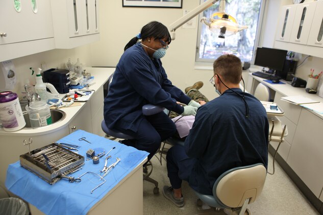 Lakita Jackson, a dental assistant, prepares a patient for an operation at the Marine Corps Recruit Depot Parris Island Dental Clinic, Jan. 24. Jackson is a graduate of the American Red Cross Dental Assisting Program and was hired at the MCRD Dental Clinic after completing the program seven years ago.