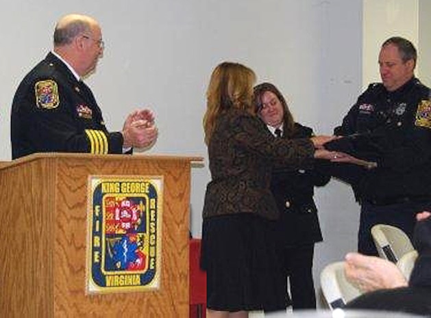 Dave Garvin (far right) of Marine Air-Ground Task Force Command, Control and Communications receives an award for running more than 100 calls for King George Fire and Rescue during 2012, his fourth year in a row reaching this prestigious level. Garvin was presented the President's Call to Service Award Jan. 16, 2013.