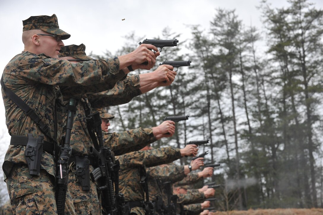 Guard Co. Marines fire their pistols from 10-yards away from their targets during a training exercise on the High Risk Personnel Course at Weapons Training Battalion on Jan. 30. The training that took place was Guard Co. basic infantry school level training