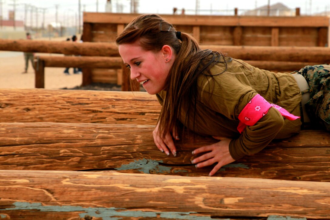 Samantha Ducharme, wife of Lance Cpl. Tristofer Ducharme, mortarman, Weapons Co, 3rd Battalion, 7th Marine Regiment, traverses the obstacle course Jan. 24, 2013. Ducharme finished the obstacle course the fastest in her group.  