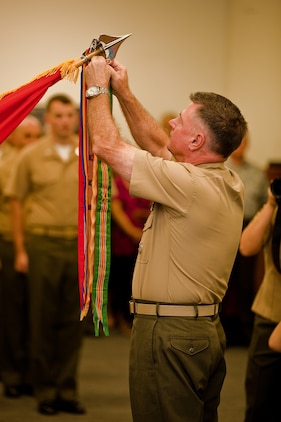 Lt. Gen. Terry G. Robling, commander of U.S. Marine Corps Forces, Pacific, attaches a Meritorious Unit Commendation streamer with a bronze star to the MarForPac colors here Feb. 1. Marines at MarForPac were awarded a MUC for spearheading the Corps’ rebalance toward Asia-Pacific from Sep. 1, 2010 to Aug. 31, 2012. 