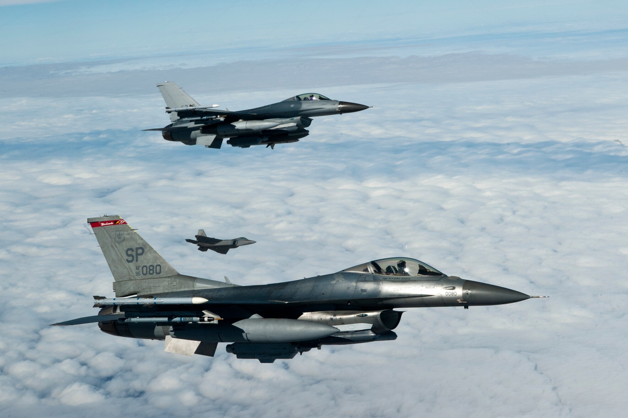 Two F-16 Fighting Falcons from the 52nd Fighter Wing, Spangdahlem Air Base, Germany, and an F-22 Raptor, 199th Fighter Squadron, Joint Base Pearl Harbor-Hickam, Hawaii, prepare to refuel during Red Flag 13-2 above the Nevada Test and Training Range Jan. 25, 2013. The mission of Red Flag is to maximize the combat readiness and survivability of participants by providing a realistic training environment and a forum that encourages a free exchange of ideas. (U.S. Air Force Photo by Airman 1st Class Jason Couillard)