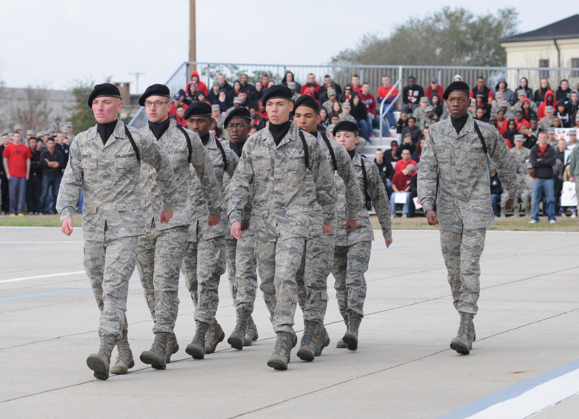 Members of the 338th Training Squadron regulation drill competition team enter the field to perform during the first drill down of the season Feb. 1, 2013, at the Levitow Training Support Facility, Keesler Air Force Base, Miss.  The 338th TRS was the overall winner of the drill down, with the 335th TRS taking second and the 336th TRS in third.  (U.S. Air Force photo by Kemberly Groue)