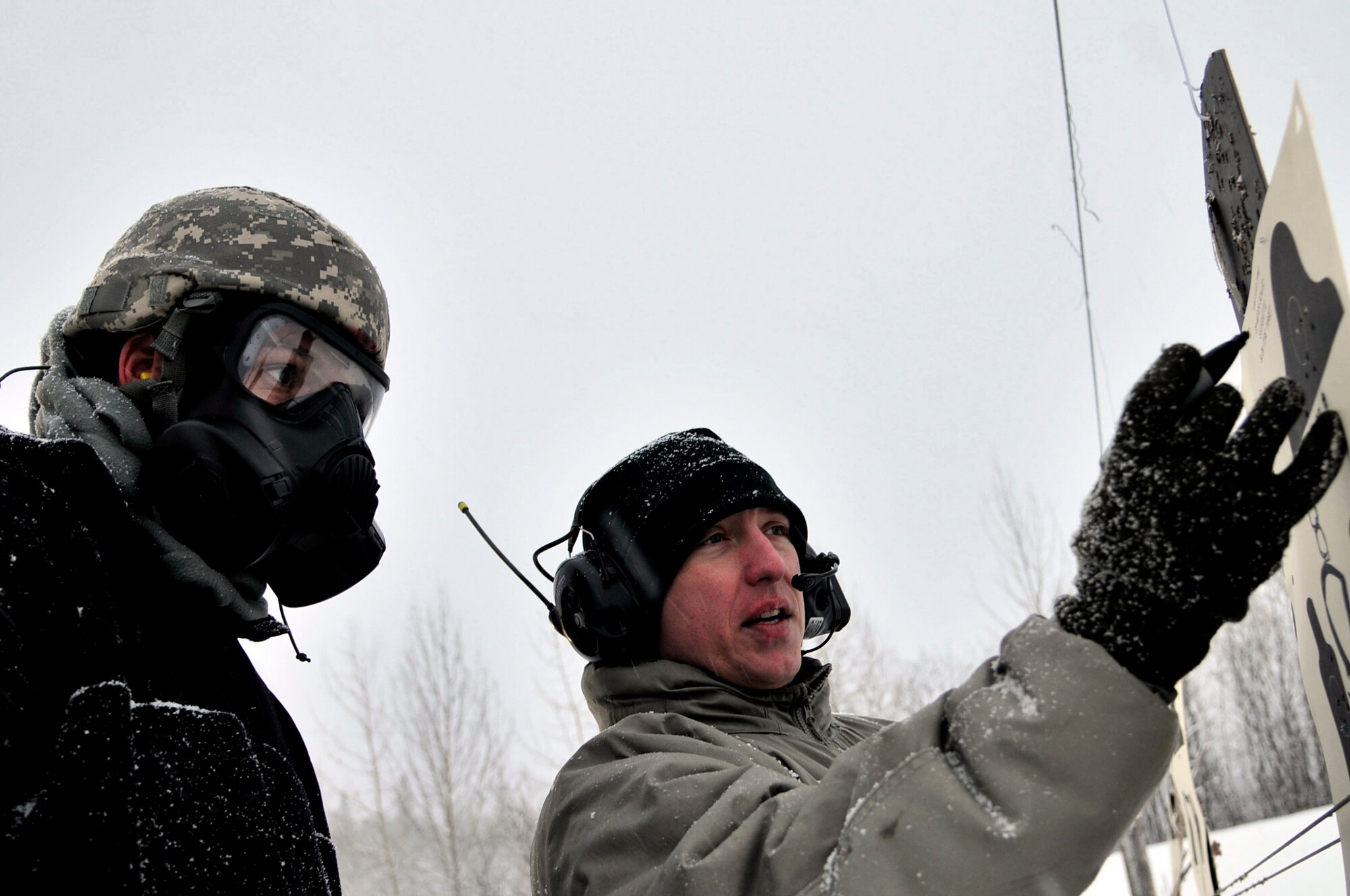 Tech. Sgt. Levi Brown, 354th Security Forces Squadron combat arms section NCO in charge, evaluates a target during SF augmentee training Jan. 24, 2013, Eielson Air Force Base, Alaska. Part of augmentee training requires Airmen to meet weapons skills training standards and later instructors review each individual’s performance. (U.S. Air Force photo/ Senior Airman Yash Rojas)