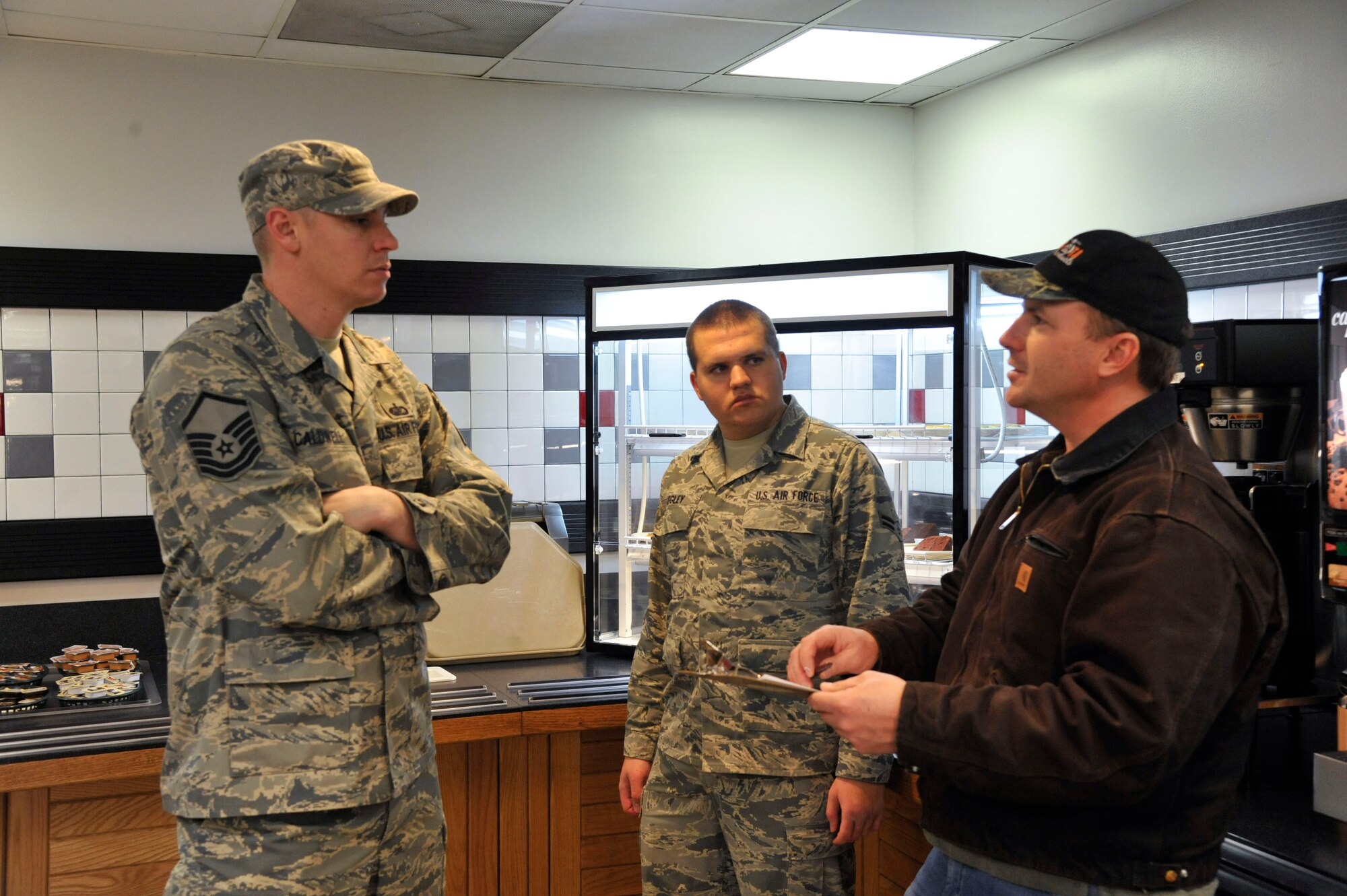 WHITEMAN AIR FORCE BASE, Mo -- David Neuman, 509th Civil Engineer Pest Management Technician, and Airman 1st Class Zachary Kegley, 509th Civil Engineer Squadron Pest Management Apprentice, explains inspection review to Master Sgt. Robert Caldwell, 509th Force Support Squadron Dining Facility Superintendent, Jan. 23. Neuman is giving Caldwell tips on what to improve on and maintain a pest-free environment. (U.S. Photo by Airman 1st Class Keenan Berry) (Released)