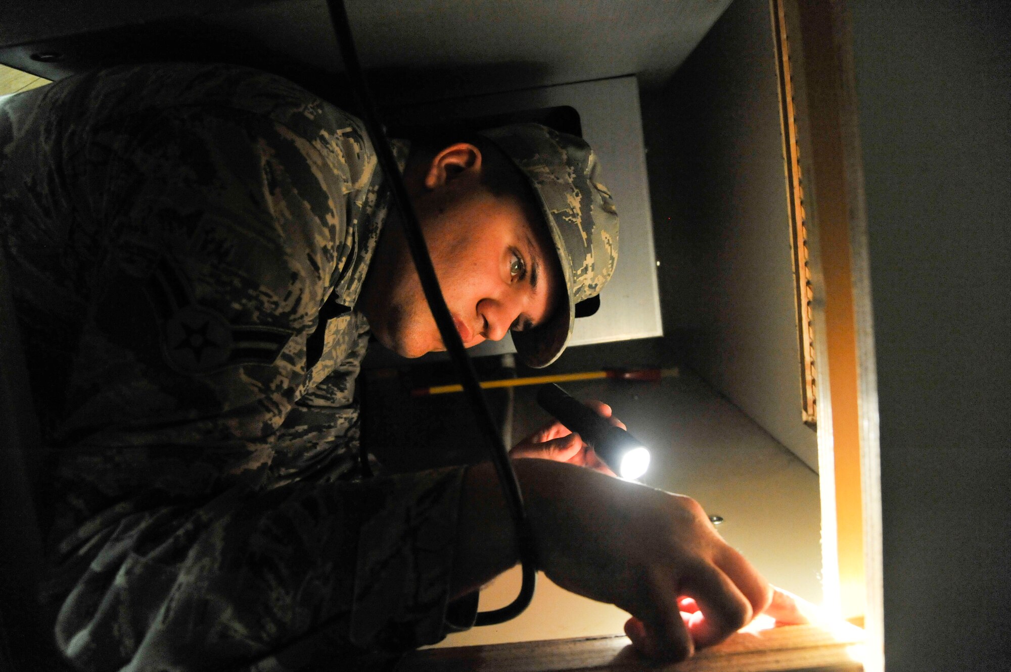 WHITEMAN AIR FORCE BASE, Mo. -- Airman 1st Class Zachary Kegley, 509th Civil Engineer Squadron Pest Management Apprentice, looks for pests, Jan. 23. Kegley is searching for any traces of species in the area so he will know if it is necessary to lay down trappers. (U.S. Photo by Airman 1st Class Keenan Berry) (Released)