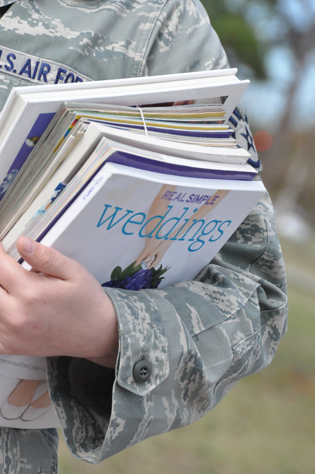 An Airman takes her selection of books for checkout at the book sale at the base library. Proceeds from the Feb. 1 and 2 sales will go toward Tyndall Library programs and the Gulf Coast State College Armed Forces Club, who volunteered to run the sale. The club welcomes veterans to college life and performs community service activities. (U.S. Air Force Photo/Ashley M. Wright)