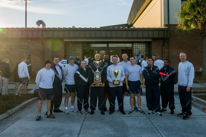 (Right) Col. Darren Hartford, 437th Airlift Wing commander, presents the Commander’s Spirit Award to Airmen from the 437th Aircraft Maintenance Squadron after the Commander’s Challenge Run, Feb. 1, 2013, at Joint Base Charleston – Air Base, S.C. The Commander's Challenge is held monthly to test Team Charleston's fitness abilities (U.S. Air Force photo/ Senior Airman George Goslin)