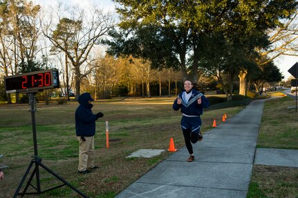 Capt. Mary Stanton, 16th Airlift Squadron pilot, crosses the finish line during the Commander's Challenge Run Feb. 1, 2013, at Joint Base Charleston – Air Base, S.C. Stanton finished with a time of 21 minutes, 30 seconds. The Commander's Challenge is held monthly to test Team Charleston's fitness abilities. (U.S. Air Force photo/ Senior Airman George Goslin)