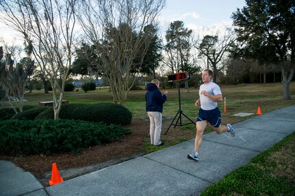 Senior Airman Joseph Schlank, 437th Aerial Port Squadron passenger service agent, crosses the finish line during the Commander's Challenge Run Feb. 1, 2013, at Joint Base Charleston – Air Base, S.C. Schlank finished with a time of 18 minutes, 16 seconds. The Commander's Challenge is held monthly to test Team Charleston's fitness abilities. (U.S. Air Force photo/ Senior Airman George Goslin)
