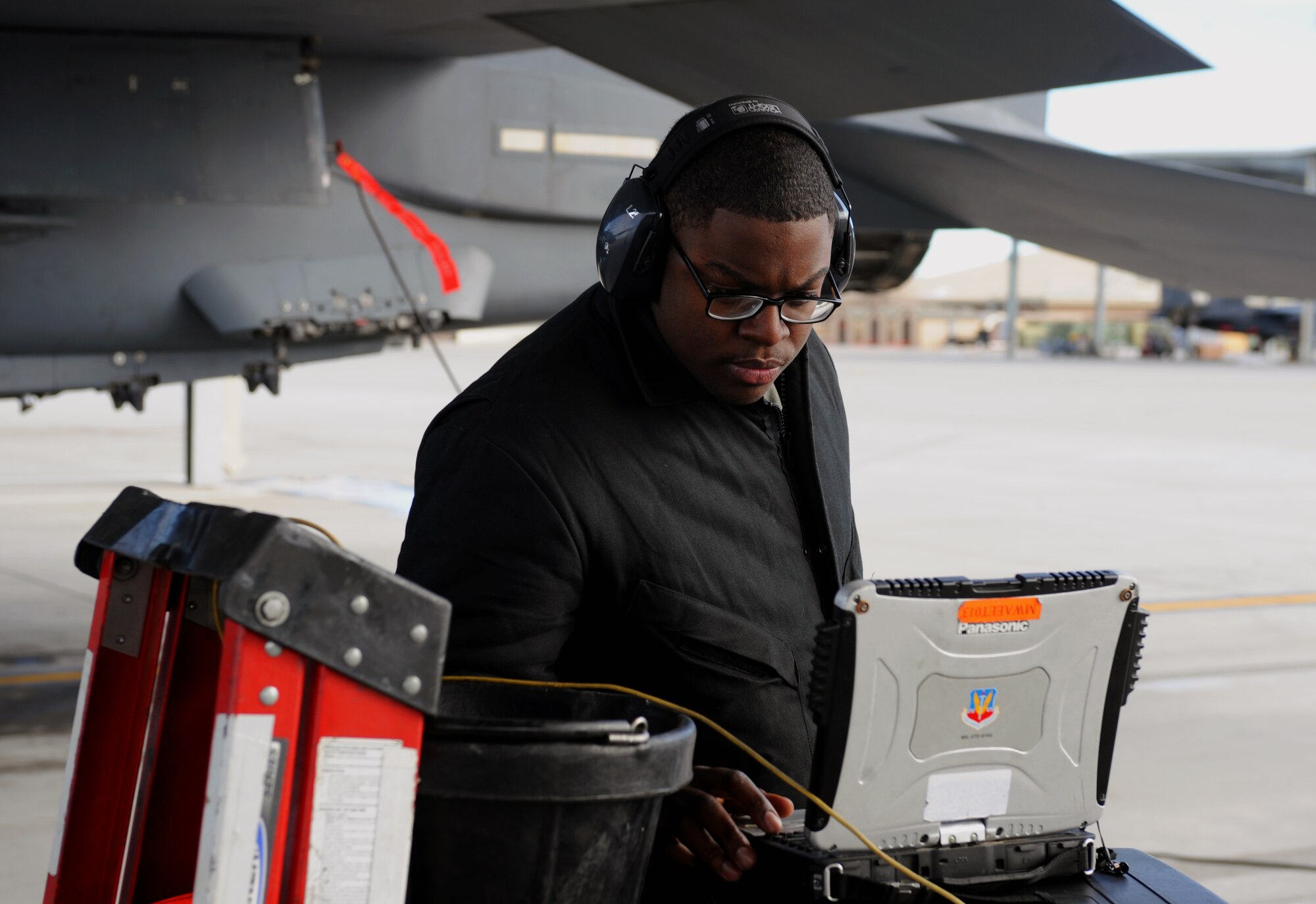 U.S. Air Force Senior Airman Tyrin Rush, 366th Aircraft Maintenance Squadron crew chief for the Bold Tigers, uses his laptop to read the steps to a task he is performing at Mountain Home Air Force Base, Idaho.  He does this so he doesn’t skip a step or do anything incorrectly because all maintenance must be done in accordance with Technical Orders, which are on the laptop. (U.S. Air Force photo/Senior Airman Benjamin Sutton) 