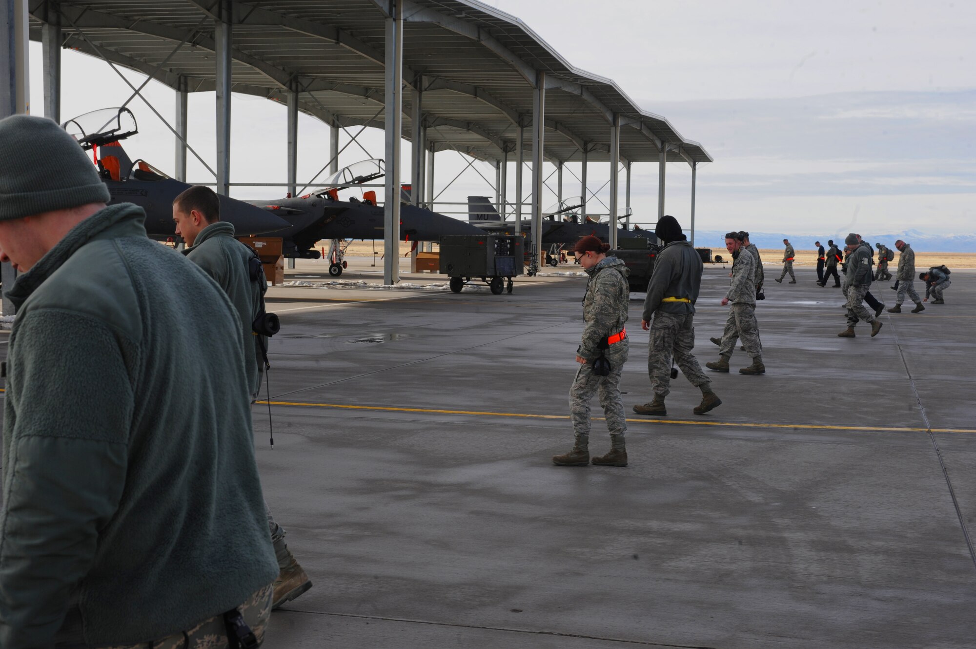 Personnel from Mountain Home Air Force Base, Idaho, conduct a foreign object and debris walk across the flightline at Mountain Home Air Force Base, Idaho. Members of the Logistics Compliance Inspection Team have reviewed virtually every aspect of maintenance and flightline operations throughout the week. (U.S. Air Force photo/Senior Airman Benjamin Sutton) 