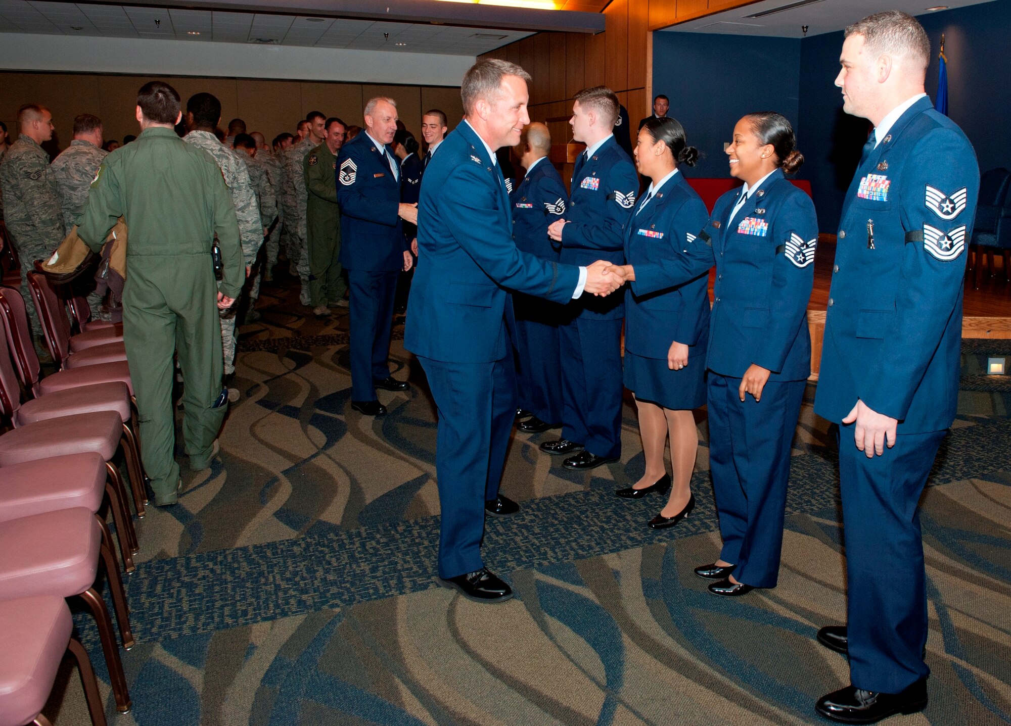 February promotes receive handshakes from fellow Airmen of Team Tyndall Jan. 31 at the Horizons Community Activity Center. (U.S. Air Force photo by Lisa Norman)